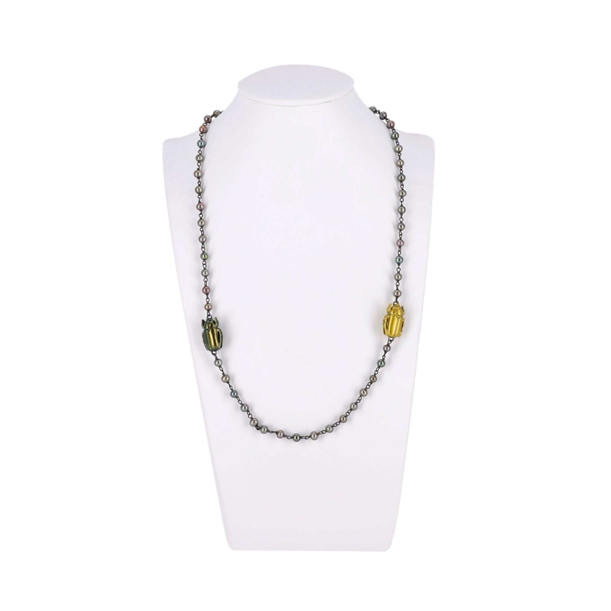 Rare Item -  Scarab Necklace With Fresh Water Pearls, Oxidized Sterling Silver & Gold Plated 

From the 2010 collection by Tomas Maier is this rare necklace with fours scarab beetles.

Two in blackened silver and the others in gold on a string on