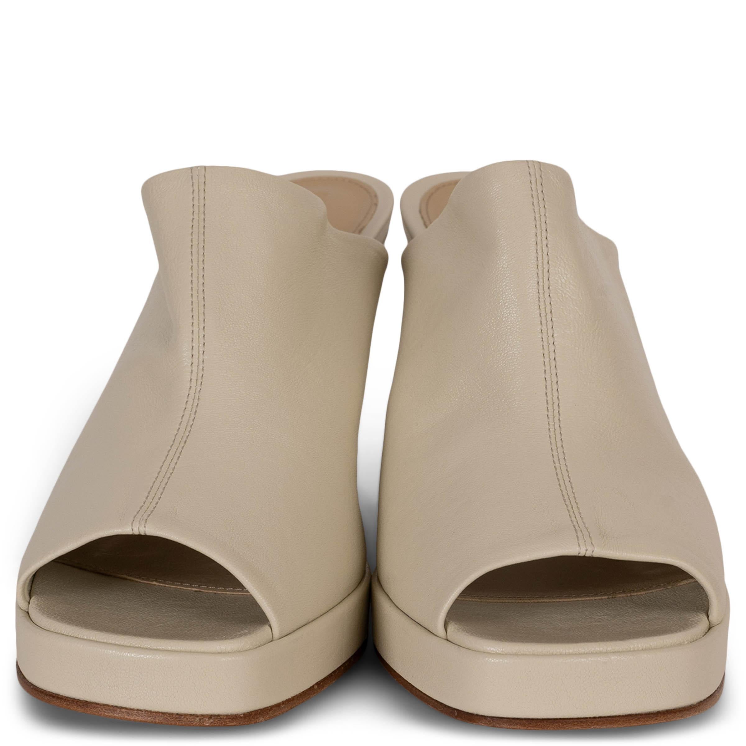 This 100% authentic Bottega Veneta Stack mule sandal in Sea Salt (cream) leather showcases sculptural elegance. Designed with open square toes, a leather-covered wedge heel, and a slight platform, the slip-on silhouette offers both bold style and
