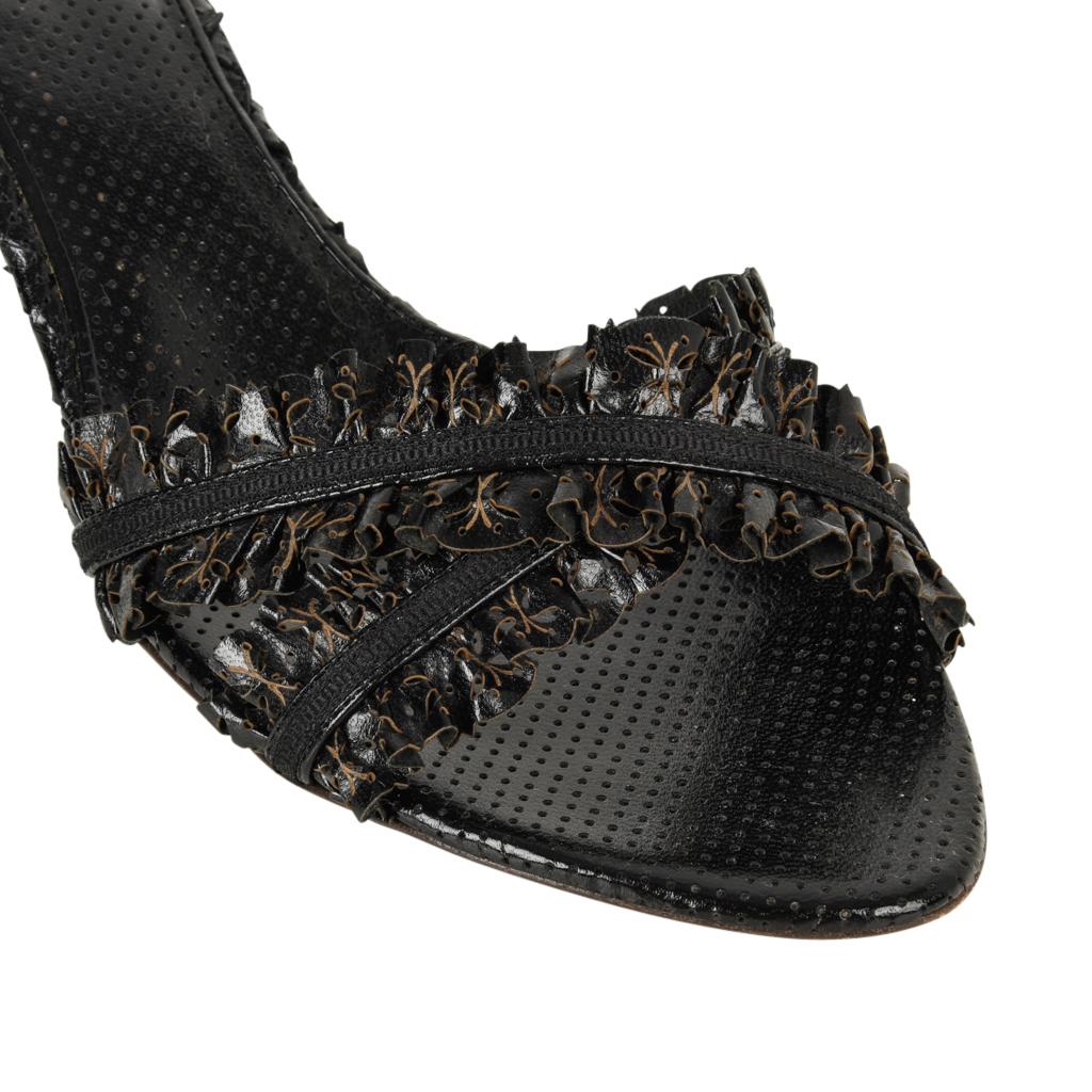 Guaranteed authentic Bottega Veneta marvelous mule.  The entire mule is covered in perforated black leather.
The under sole and edge is woven leather. 
2 Straps criss cross over the foot.
Each strap is a 'ruffle' of leather on each side of a thin