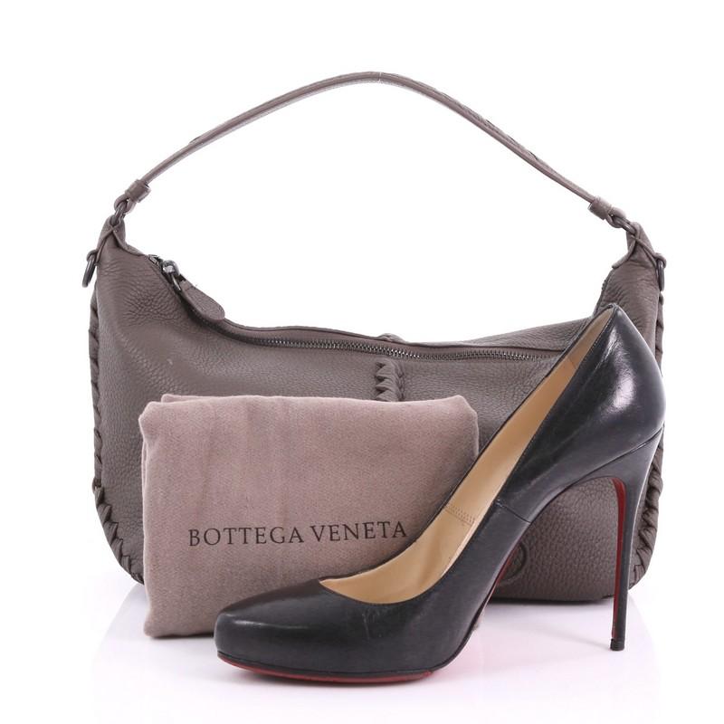 This Bottega Veneta Shoulder Bag Cervo Leather with Intrecciato Detail Medium, crafted in taupe cervo leather, features looping leather shoulder strap, leather piping details woven in Bottega Veneta's iconic intrecciato method, and gunmetal-tone