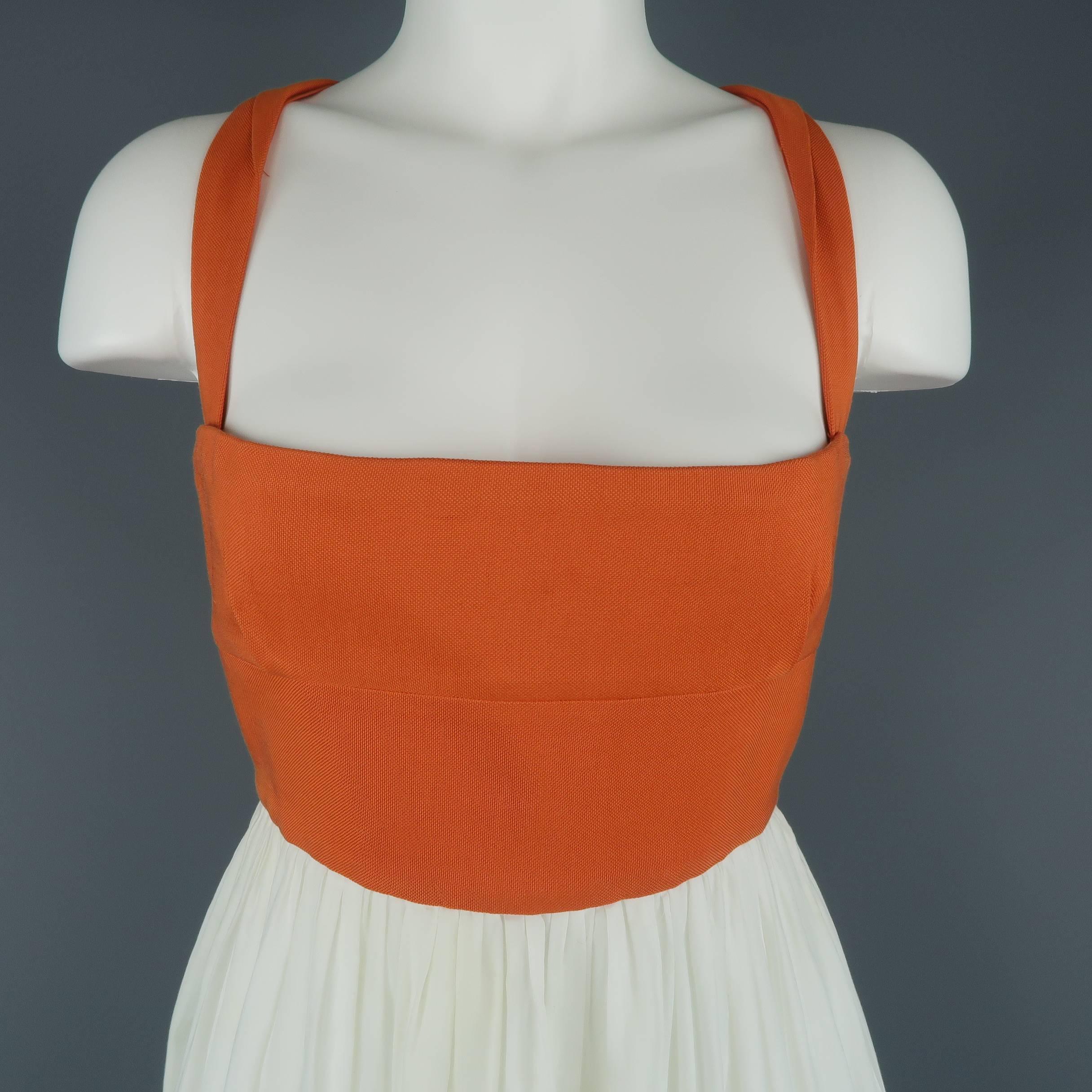 This BOTTEGA VENETA maxi dress features an orange canvas bustier top with twisted straps and hook eye back closure with a cream gathered A line skirt. Minor wear. Made in Italy.
 
Good Pre-Owned Condition.
Marked: IT 44
 
Measurements:
 
Bust: 34