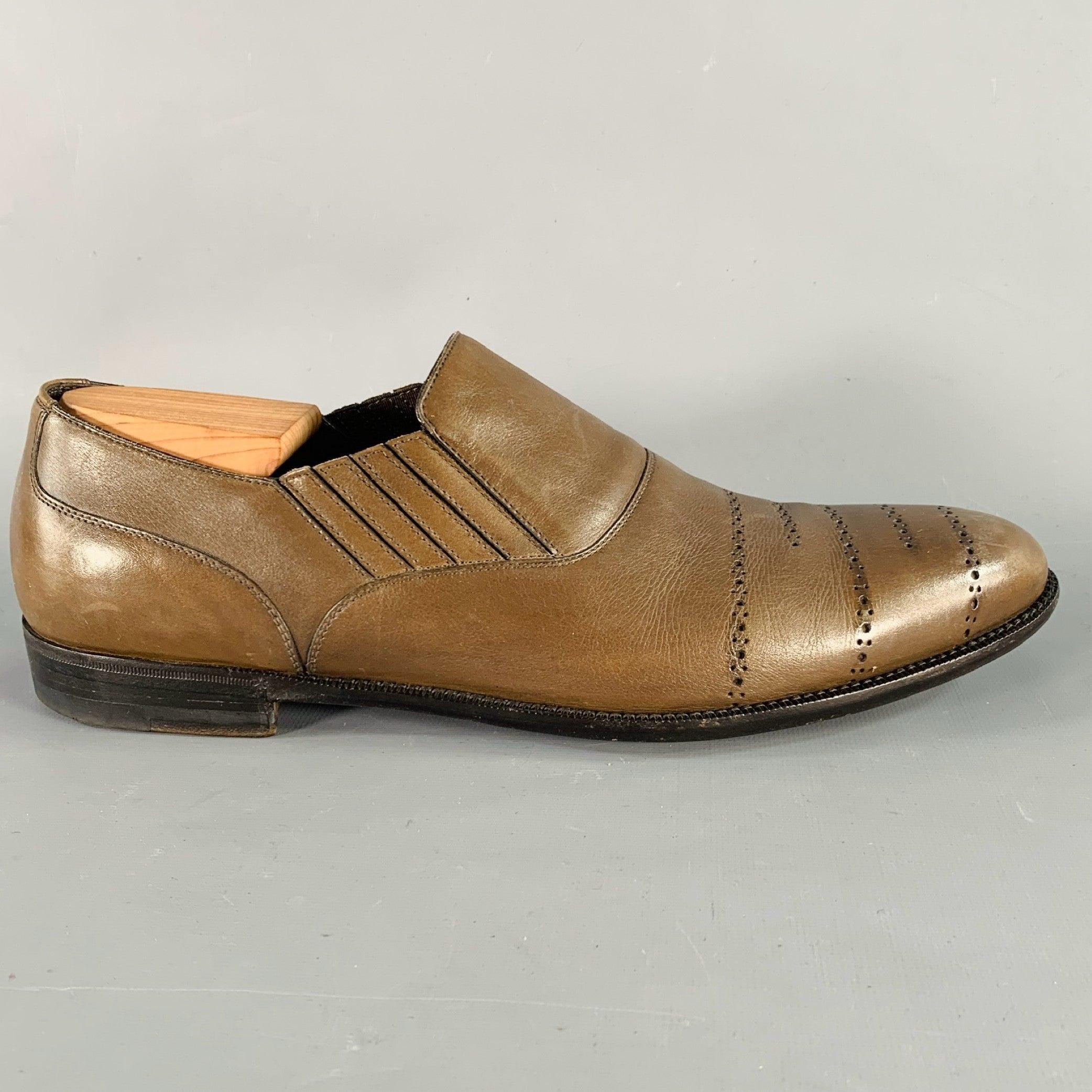BOTTEGA VENETA loafers
in a brown leather featuring a perforated lines design, low top style, and slip on closure with elastic panels. Shoe trees not included. Made in Italy.Very Good Pre-Owned Condition. Light creasing. 

Marked:   IT 44Outsole:12