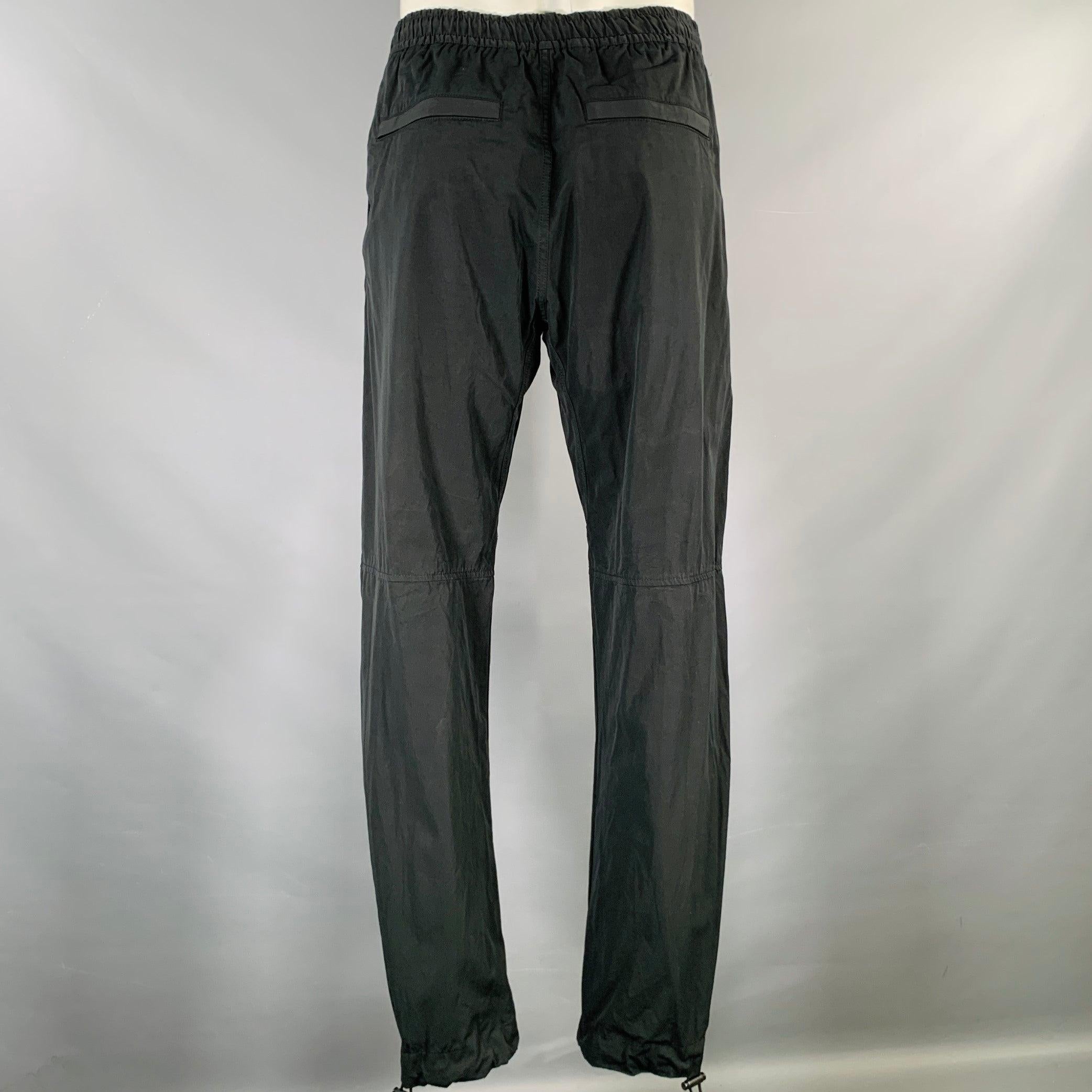 BOTTEGA VENETA by DANIEL LEE Pre-Spring 2020 casual pants
in a
black cotton blend fabric featuring a drop crotch style, drawstring cuffs, and drawstring closure. Made in Italy.New With Tags. 

Marked:   L 

Measurements: 
  Waist: 34 inches Rise: 8