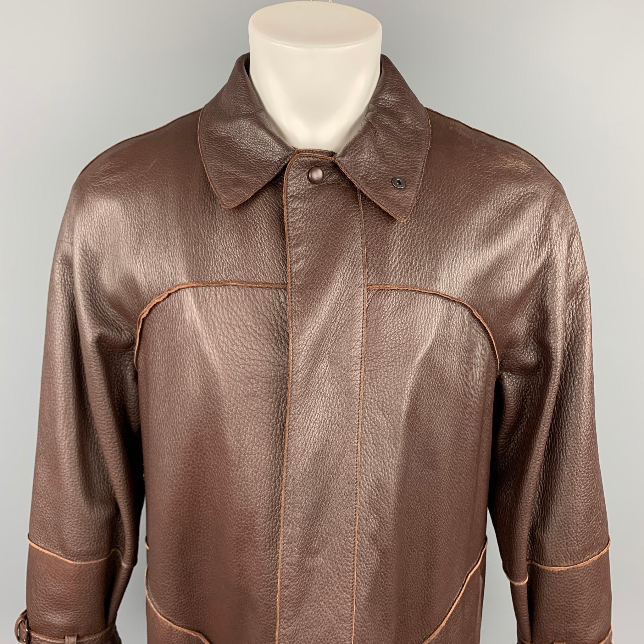 BOTTEGA VENETA coat comes in a brown leather with a full liner featuring oversized fit, belted cuffs, slit pockets, and a hidden button closure. Made in Italy.

Very Good Pre-Owned Condition.
Marked: IT 48

Measurements:

Shoulder: 19 in.
Chest: 44