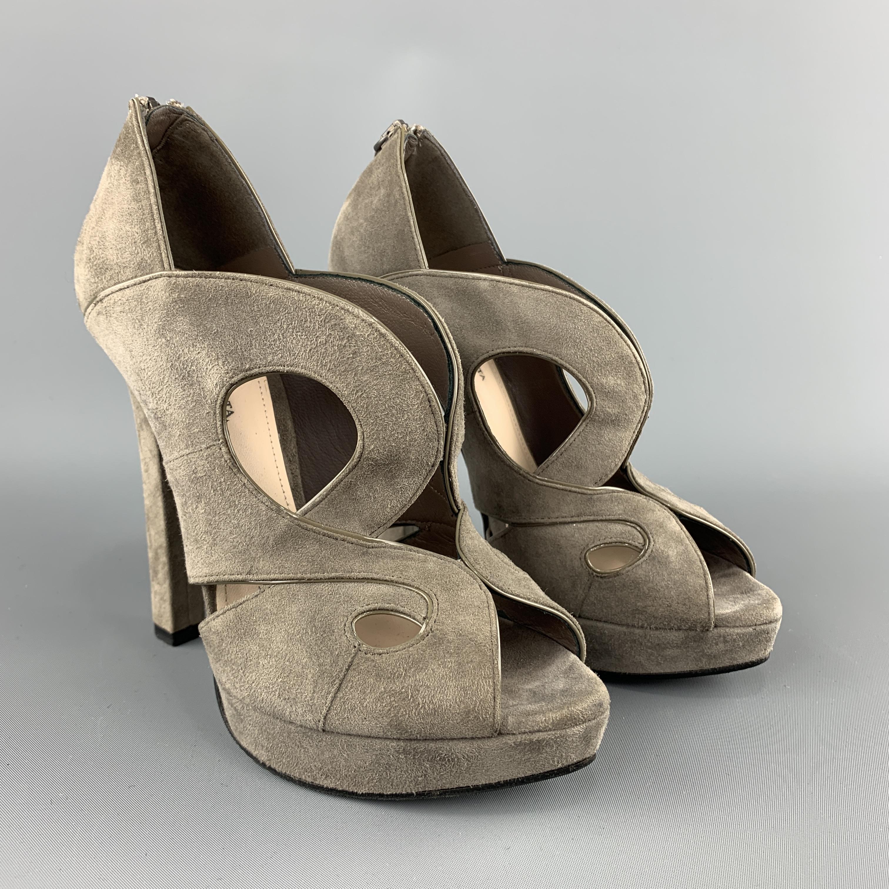 BOTTEGA VENETA sandals come in taupe gray suede with a covered heel, cutouts, peep toe, and patent leather piping. Made in Italy.
 
Very Good Pre-Owned Condition.
Marked: IT 37
 
Measurements:
 
Heel: 5 in.
Platform: 0.75 in.