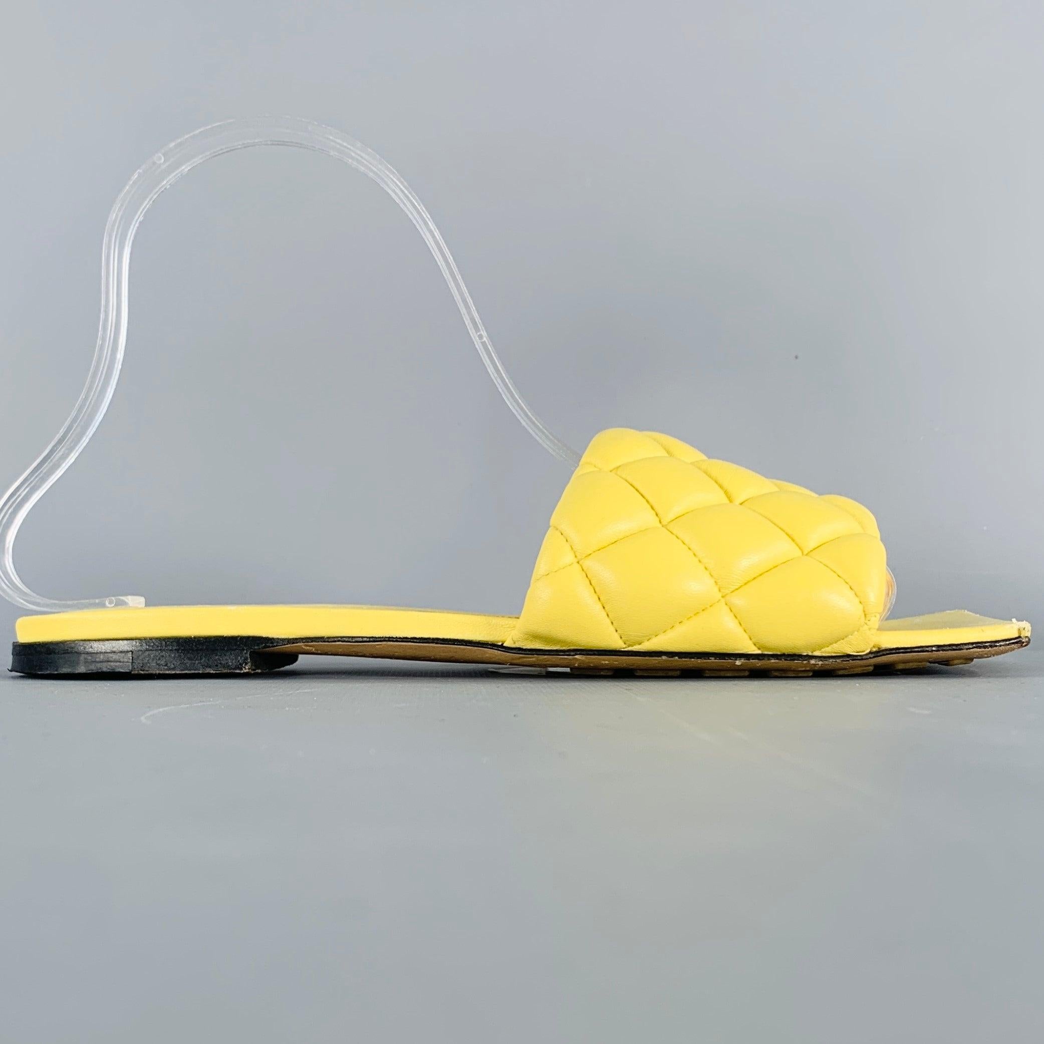BOTTEGA VENETA sandals in a yellow leather featuring a slides style, quilted design, and square toe. Made in Italy.Good Pre-Owned Condition. Moderate signs of wear. 

Marked:   37Outsole: 9.75 inches  x 3.5 inches 
  
  
 
Sui Generis Reference: