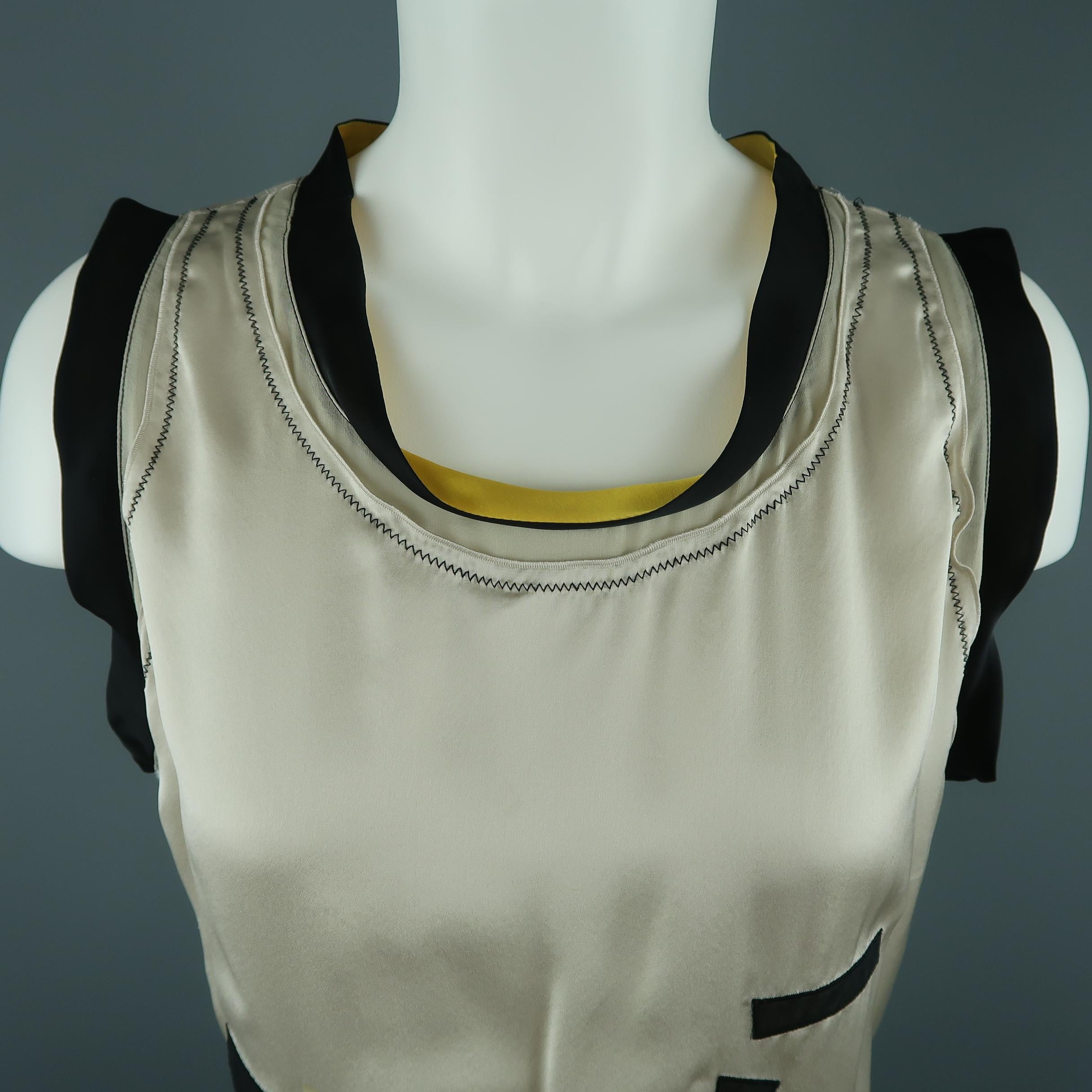 Sleeveless BOTTEGA VENETA top comes in beige silk satin with black and yellow trim scoop neck, sheer cotton geometric appliques, and chiffon side panels. Made in Italy.
 
Very Good Pre-Owned Condition.
Marked: IT 44
 
Measurements:
 
Shoulder: 14