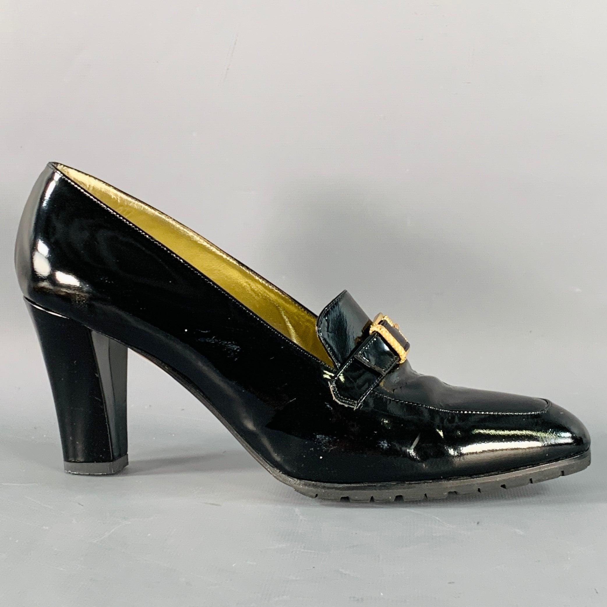 BOTTEGA VENETA pumps
in a black patent leather featuring a chunky heel, and gold tone signature BOTTEGA VENETA 