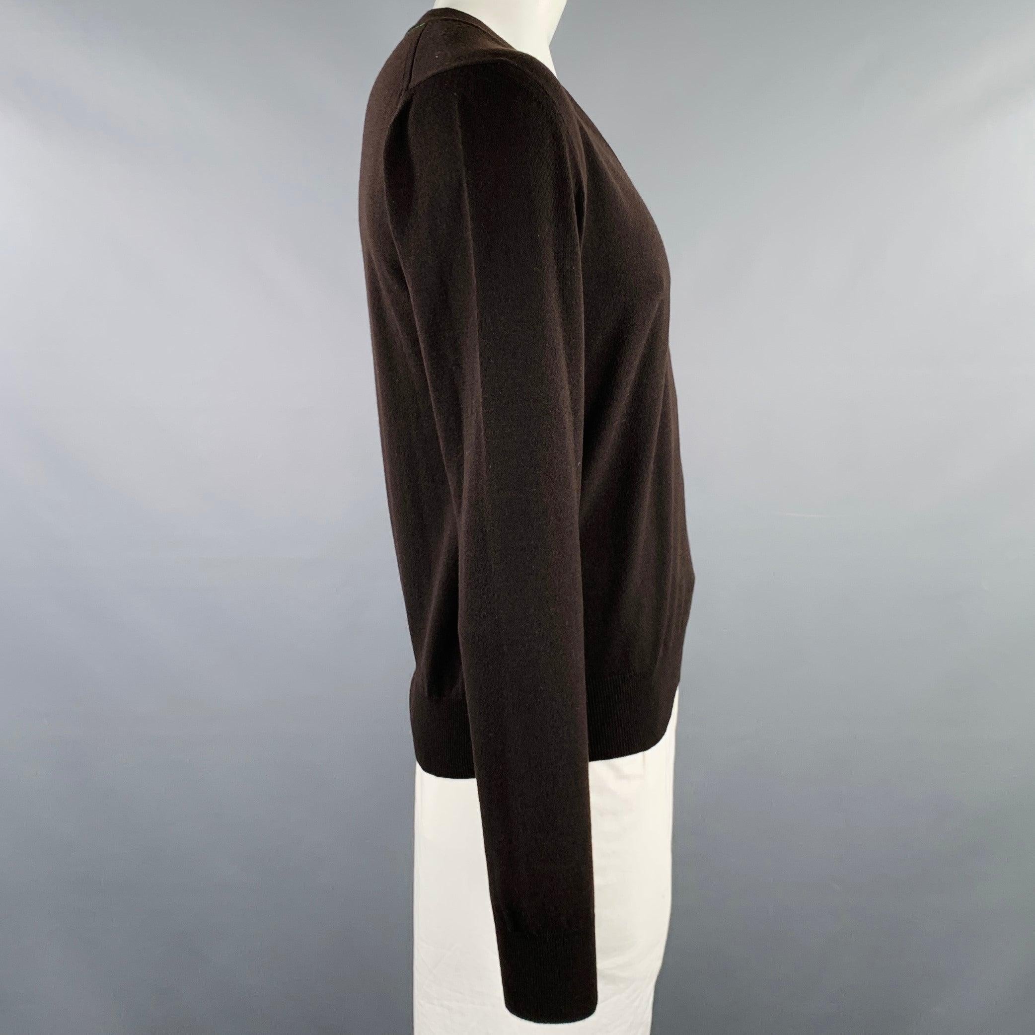 BOTTEGA VENETA pullover
in a brown wool blend knit featuring rib knit trim, and V-neck. Made in Italy.Excellent Pre-Owned Condition. 

Marked:   L 

Measurements: 
 
Shoulder: 19.5 inches Chest: 43 inches Sleeve: 29 inches Length: 25 inches 
  
  
