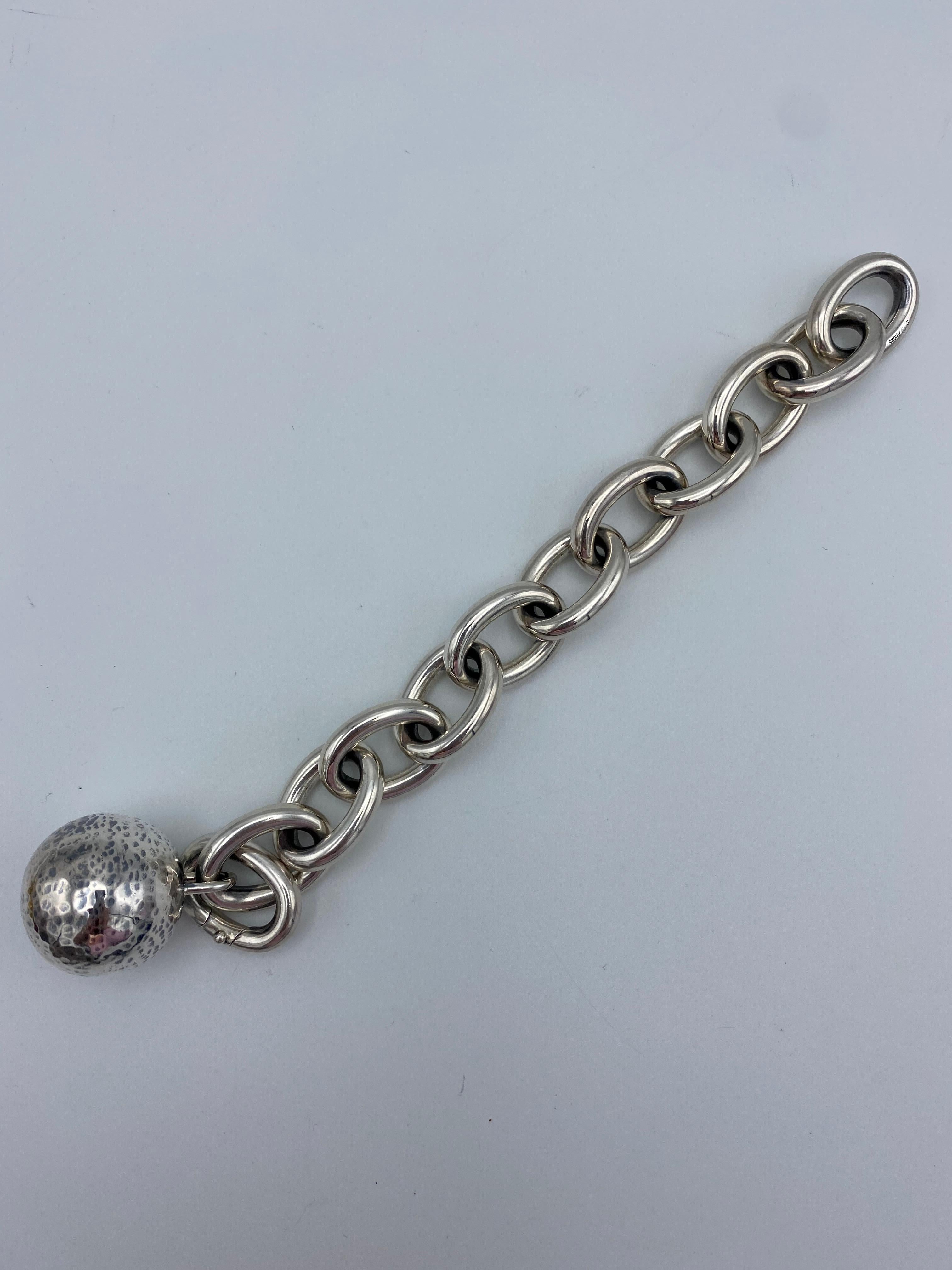 Product details:

The bracelet is designed by Bottega Veneta, it is made out of sterling silver, featuring chunky oval chain link with hammered finish ball attached and a discreet clip clasp.

Measurements: the bracelet is 8.75