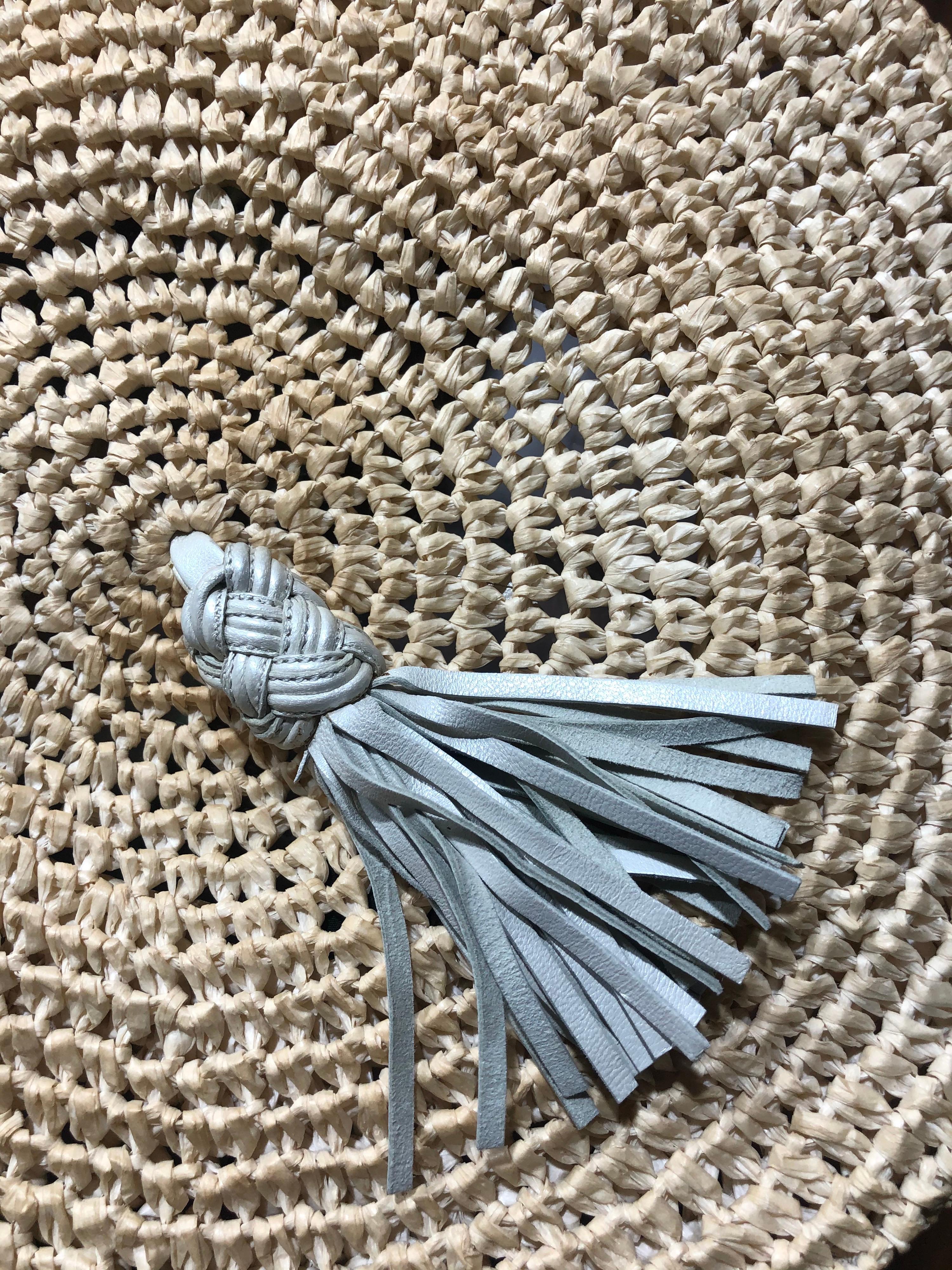 If you're a lover of Beret's than this is one to add to your collection. 1980's Bottega Veneta Beret straw hat featured with a metallic silver/white leather tassel. Dead stock with original tags. The perfect cap to style with your Chanel outfit and