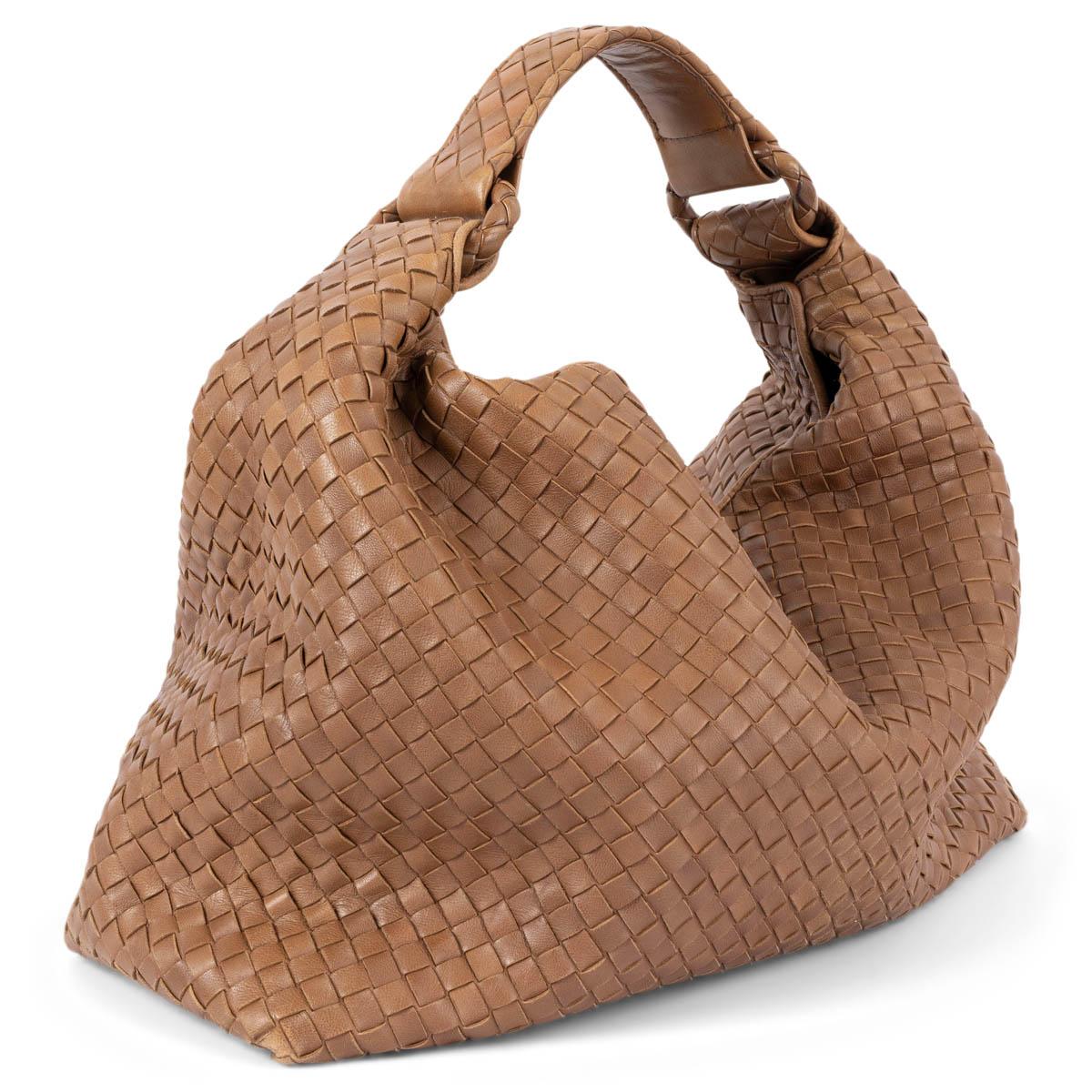 100% authentic Bottega Veneta Sloane hobo bag in tan Intrecciato leather. The design features a magnetic closure on top and is lined in beige canvas with one zipper pocket against the back. Has been carried and shows some wear to the corners and