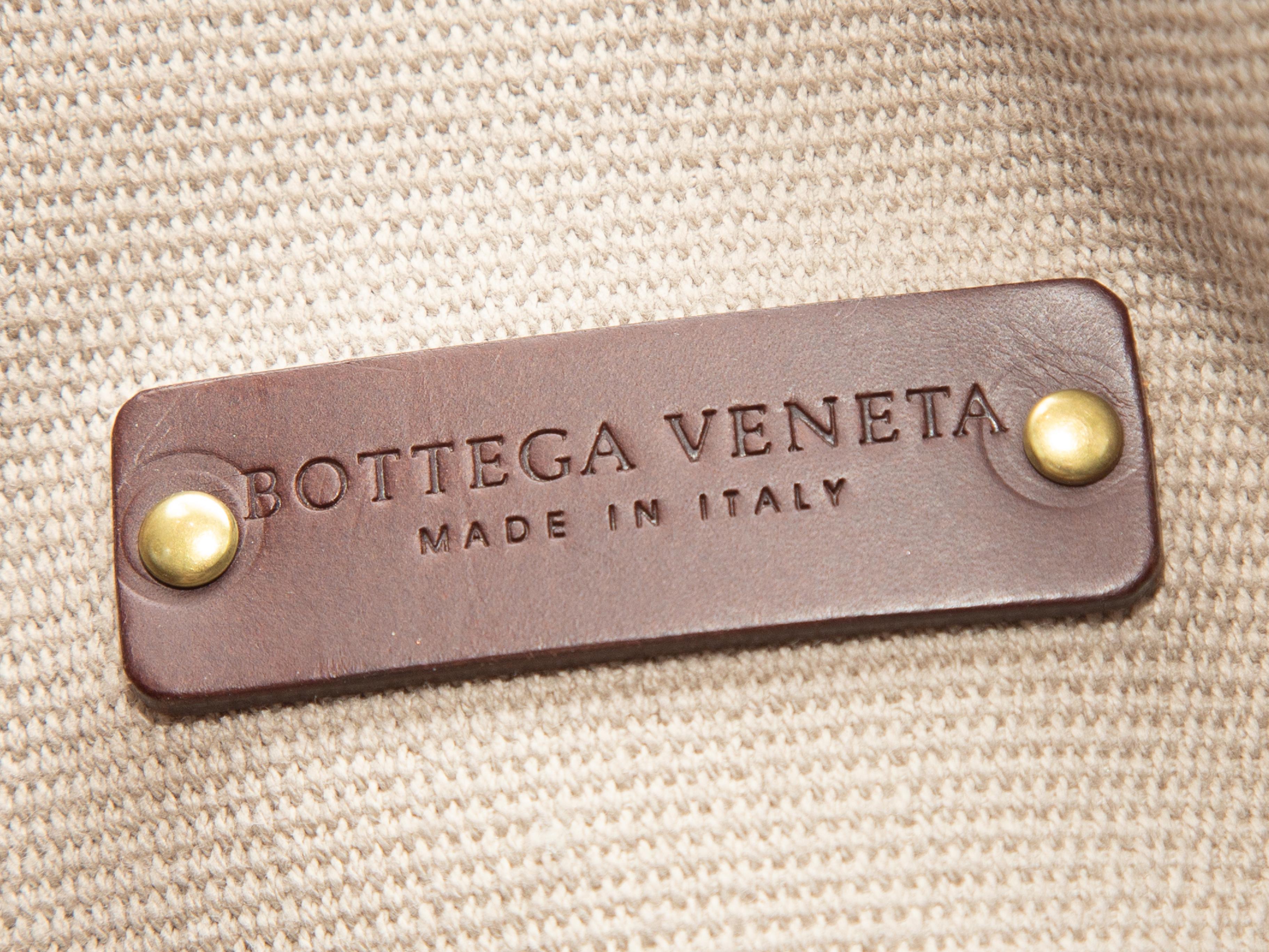 Product Details: Tan Bottega Veneta Canvas Tote Bag. This tote bag features a canvas body, gold-tone hardware, and dual leather top handles. 19.5