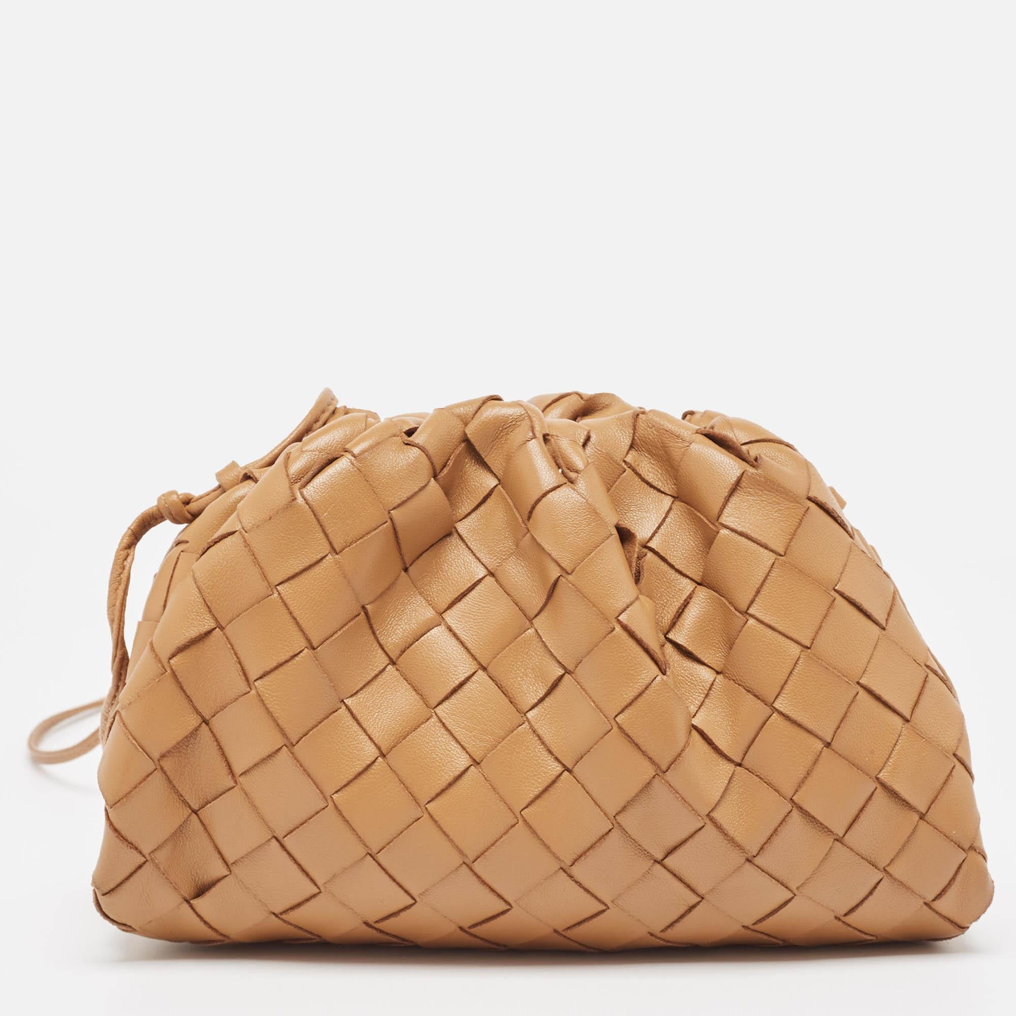 This mini The Pouch bag by Bottega Veneta is made of leather and sized down to be an easy-to-carry accessory. It has a long strap, and the interior can hold your phone and cardholder.

