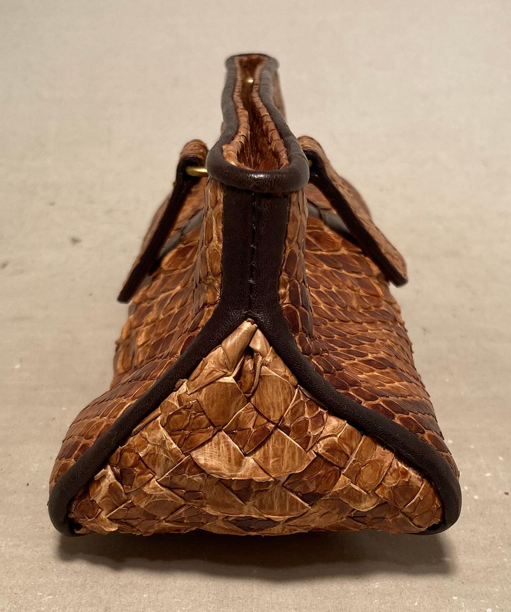Bottega Veneta Tan Snakeskin Clutch in excellent condition. Tan snakeskn exterior with black burnished edges. Hidden hinge closure with pull tabs opens to a blue suede interior. No stains smells or scuffs. Clean interior. Purchase includes a dust