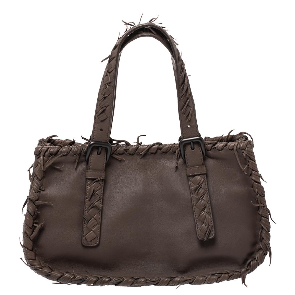 This sleek and spacious leather bag is luxurious enough to elevate any look. it is designed with intrecciato panels on the sides and bottom along with fringes on the outline as well as the handles. This bag has an inner lining of suede. Keep this