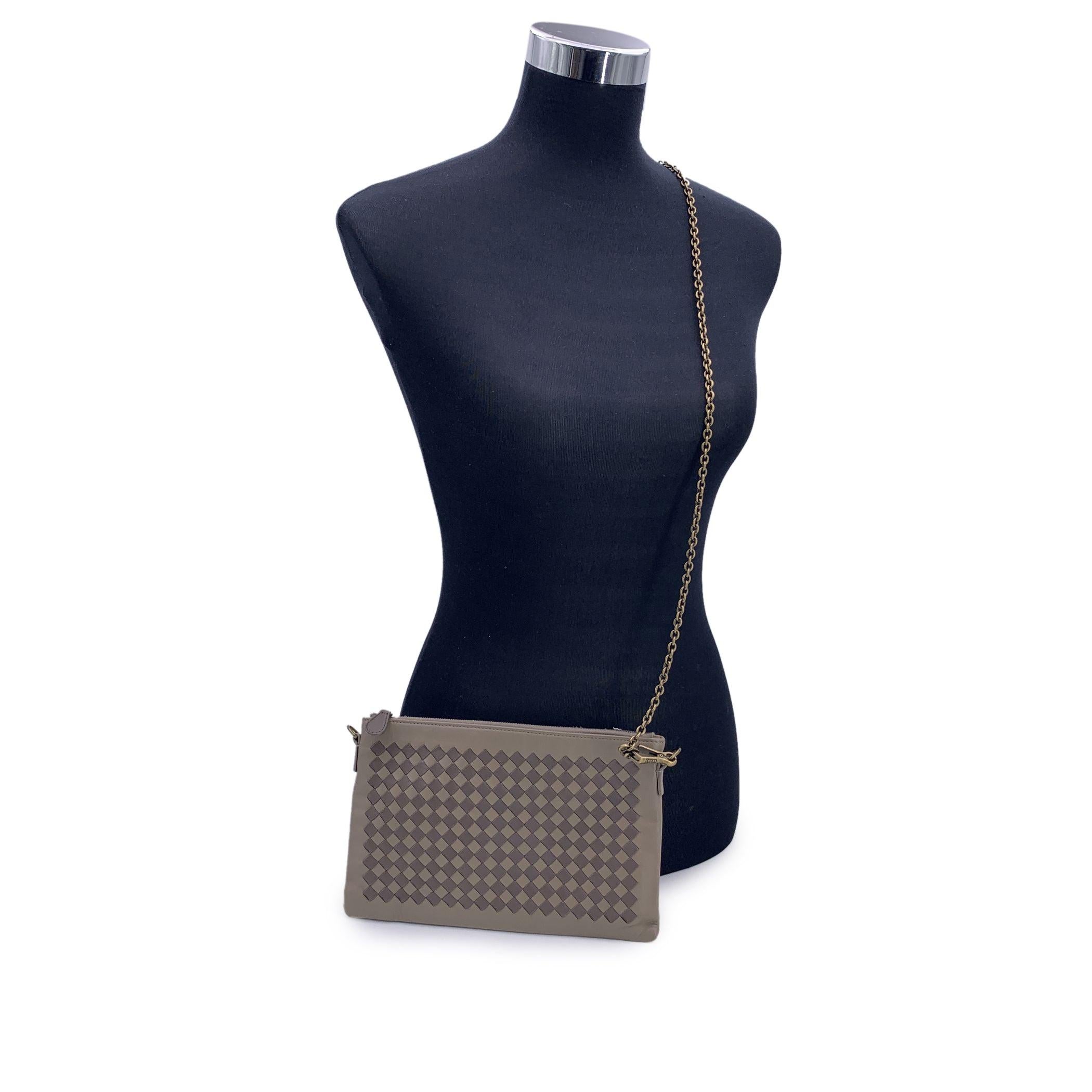 Bottega Veneta Taupe leather Zip Pouch Bag with Intrecciato woven leather on the front. Upper zipper closure. Brown suede interior with 1 side open pocket and 6 side open pockets. Removable gold metal chain strap. 'Bottega Veneta - Made in Italy'