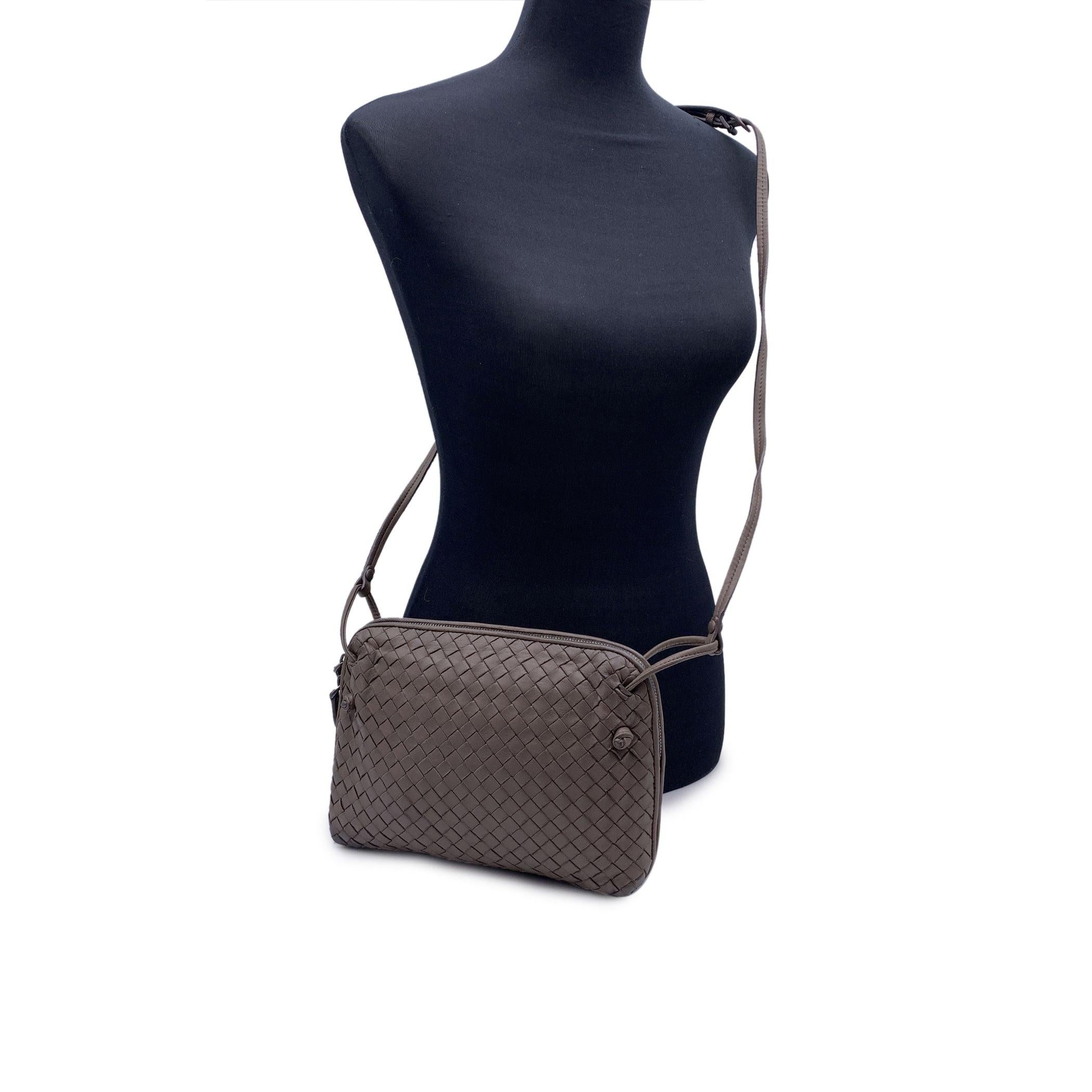 Bottega Veneta 'Nodini' shoulder bag in taupe Intrecciato woven nappa leather. Upper zipper closure. Brown suede lining. 1 side zip pocket inside. Adjustable shoulder strap. Bottega Veneta - Made in Italy' tag inside. Bottega Veneta Certification
