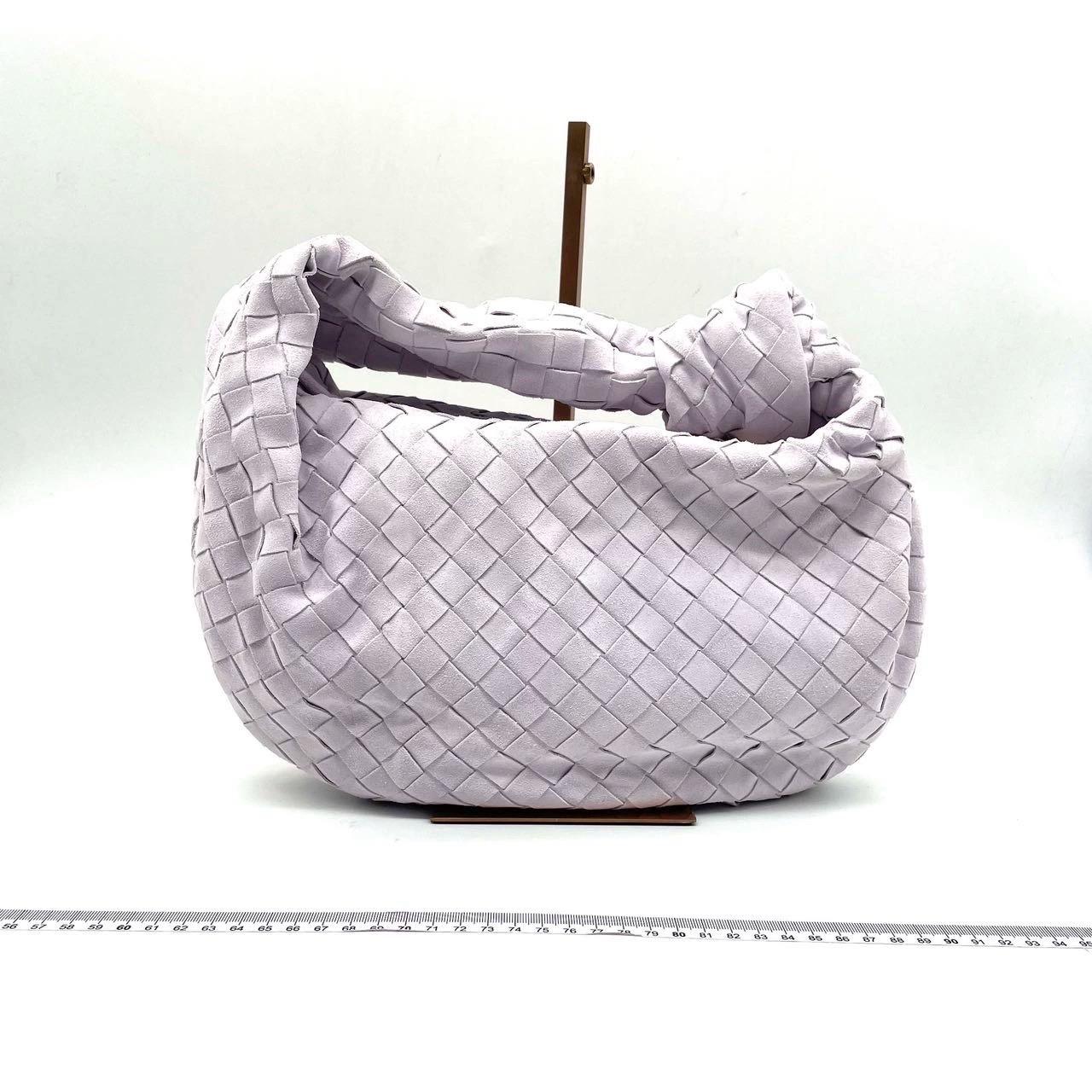 Bottega Veneta Teen Jodie Suede Washed Purple
 These are professional photos of the actual bag .
 The Bottega Veneta Jodie Medium Beige Lambskin Leather offers the perfect balance between practicality and luxury. Its medium size serves as the ideal