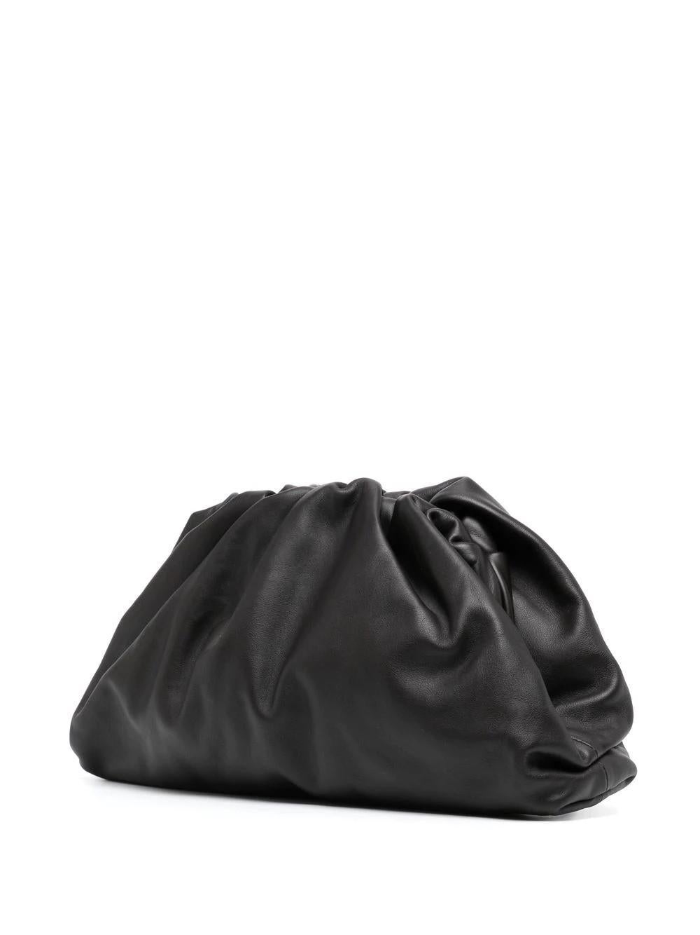 This contemporary Bottega Veneta The Pouch clutch bag features ruched detailing and slouched silhouette. Crafted in Italy from smooth black leather, it has a magnetic fastening and a compact interior with an internal logo stamp. This cult favourite