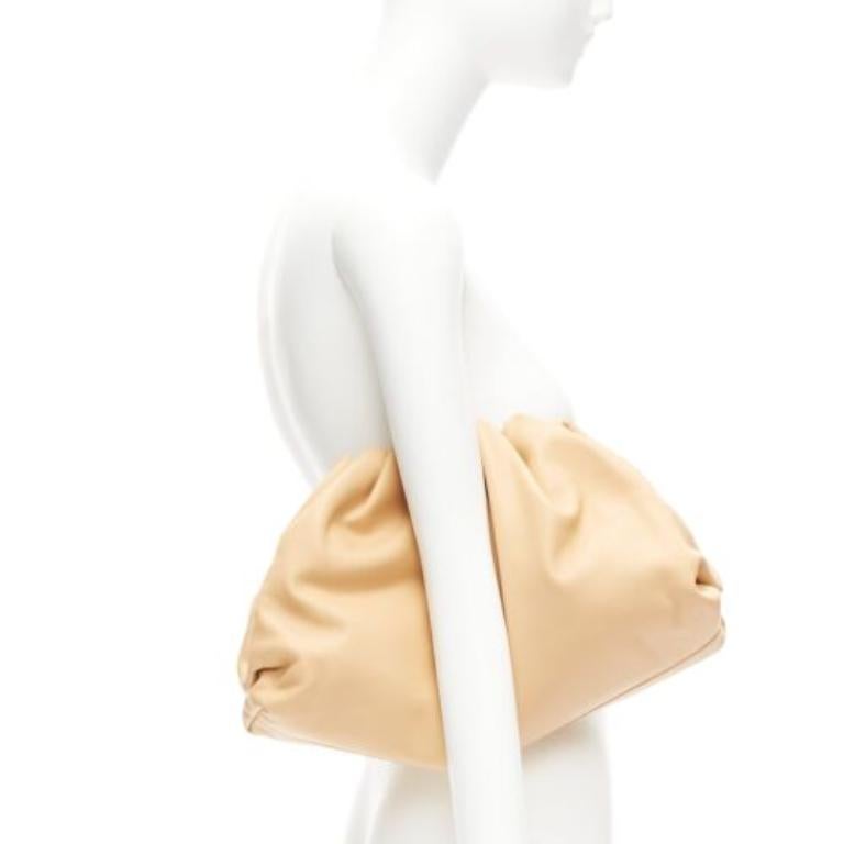 BOTTEGA VENETA The Pouch tan leather dumpling clutch bag
Reference: TGAS/D00840
Brand: Bottega Veneta
Designer: Daniel Lee
Model: The Pouch
Material: Leather
Color: Beige
Pattern: Solid
Closure: Magnet
Lining: Beige Leather
Extra Details: This piece