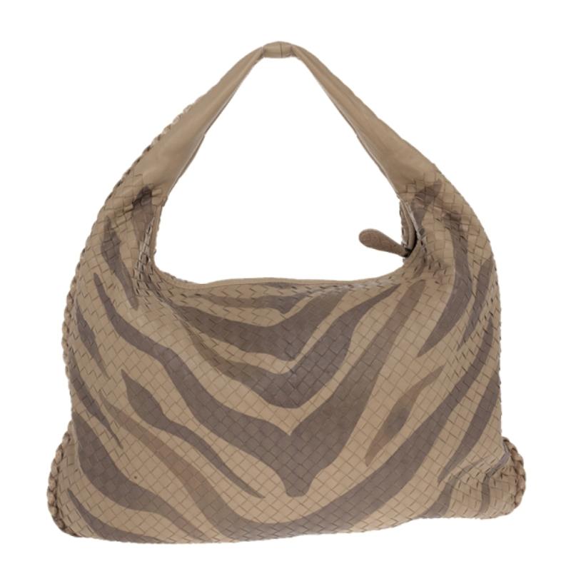 This gorgeous Limited Edition Bottega Veneta Tigre Intrecciato Woven Leather Veneta Hobo Bag is one of our favourites. It features a stunning hand painted tiger stripe pattern with Ayers snakeskin trim. It has a spacious interior that is lined with