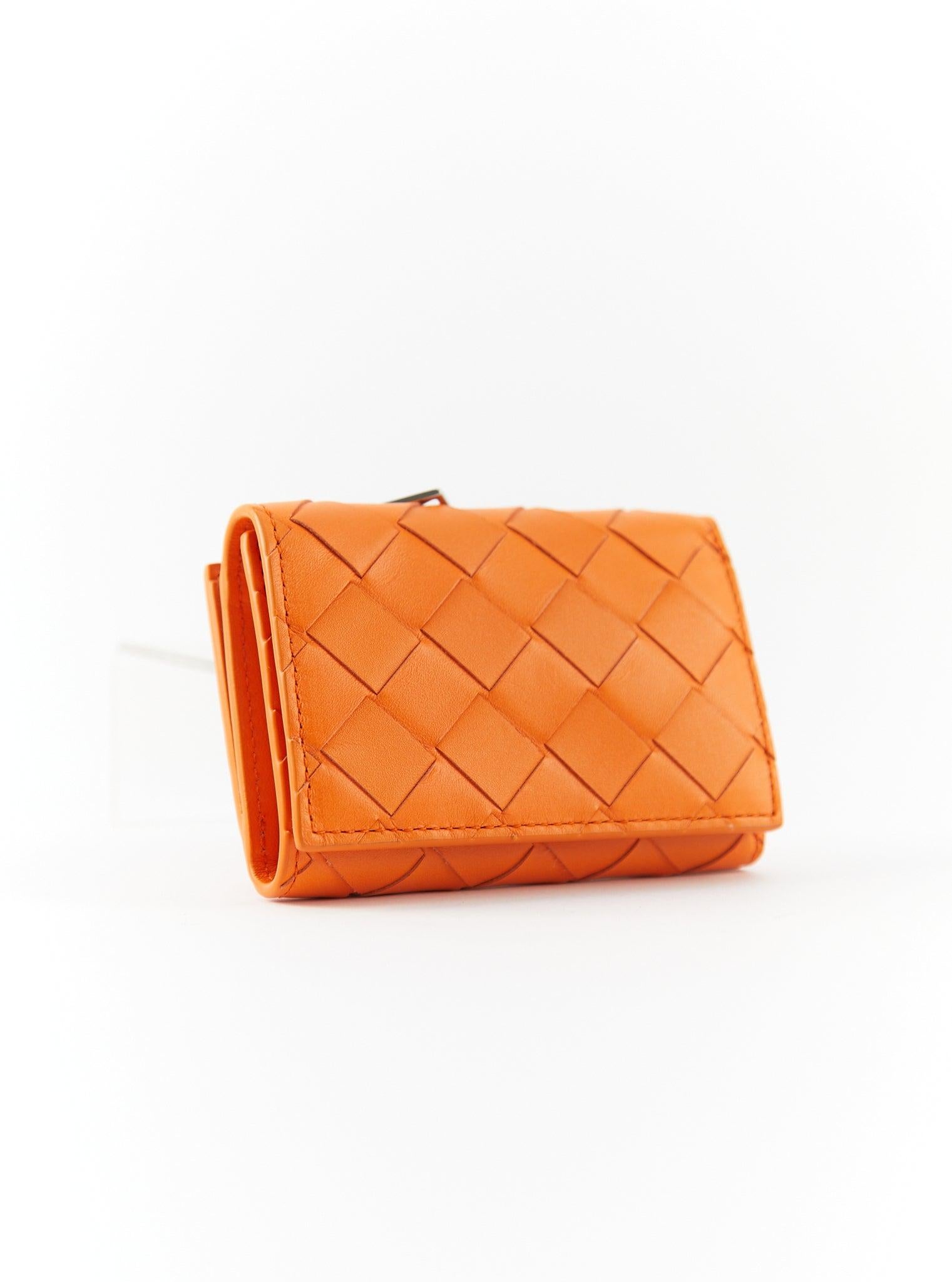 Bottega Tiny Intrecciato Tri-Fold Zip Wallet in Orange

Nappa Leather with Silver-tone Hardware

Dimensions: H 7 x W x 9.5 x D 2.5 cm

Accompanied with original box



