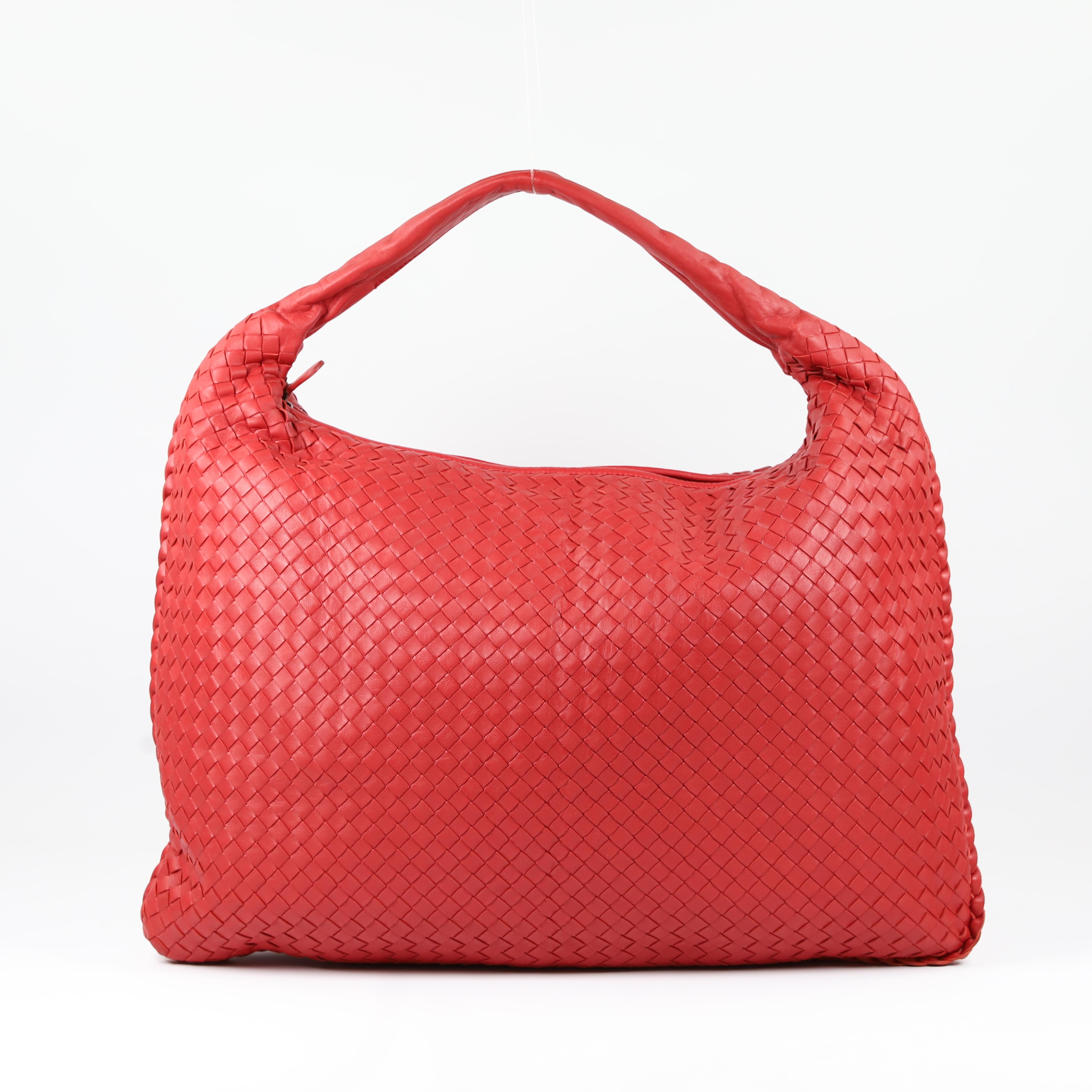 This classic Bottega Veneta Intrecciato Veneta Hobo Bag is one of our favorites. Its chic, slouchy look features Bottega's signature Intrecciato woven leather in a lovely red color. You can always count on Bottega Veneta to give us modern timeless