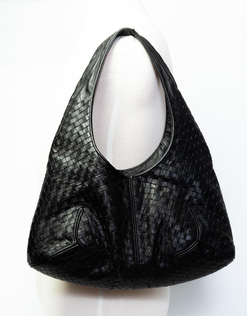 This Vintage Hobo bag by Bottega is made with the company's signature intrecciato weave with calfskin leather.

COLOR: Black
MATERIAL: Calf leather
MEASURES: H 10” x L 15.5” x D 6”
DROP: 9”
EST. RETAIL: $3000
CONDITION: Very good - exterior leather