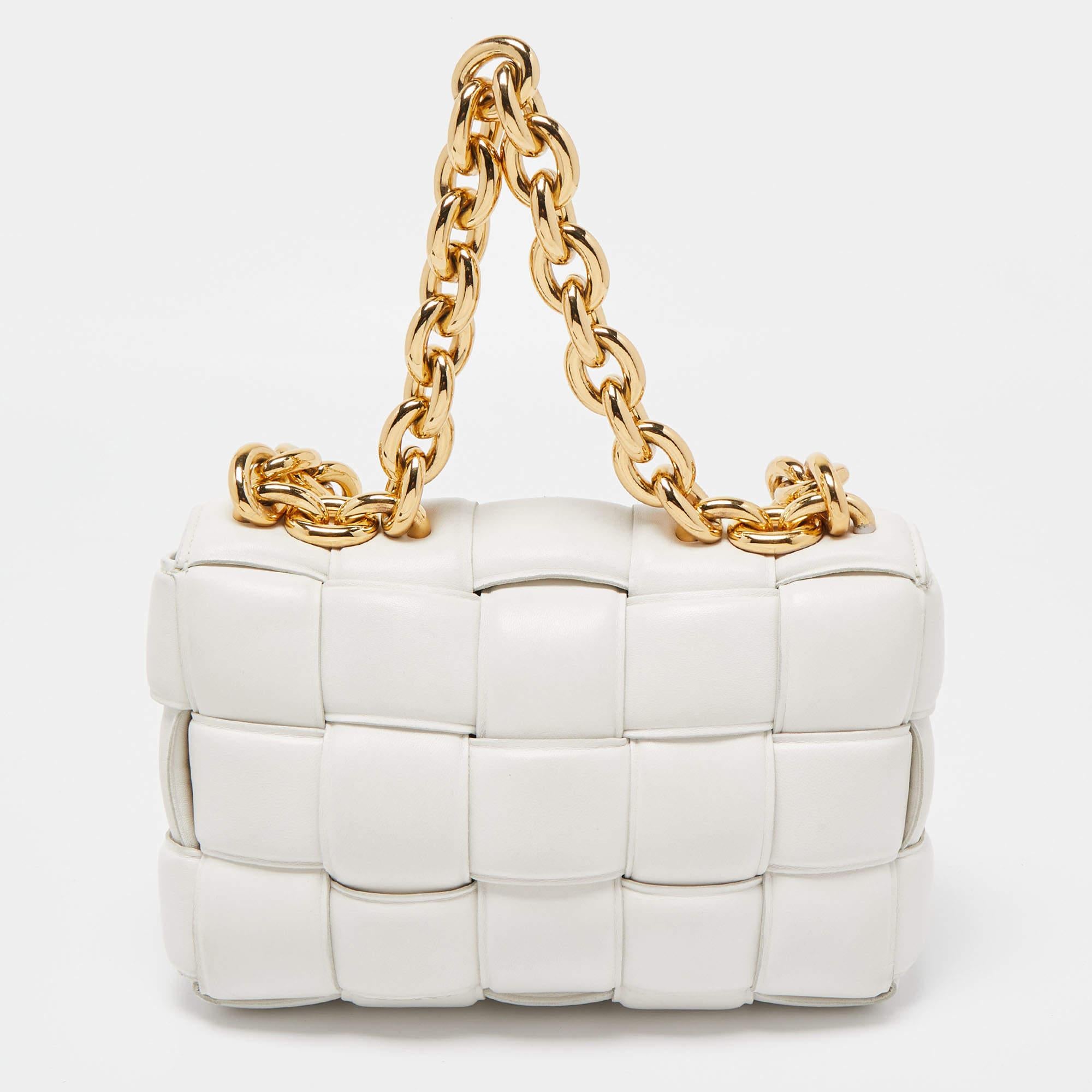 Indulge in luxury with this Bottega Veneta white Cassette bag. Meticulously crafted from premium materials, it combines exquisite design, impeccable craftsmanship, and timeless elegance. Elevate your style with this fashion accessory.

