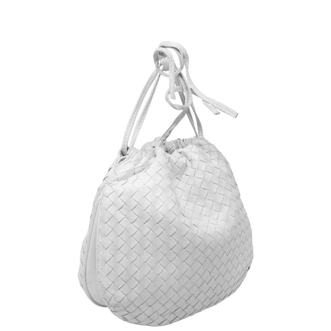 Rare and adorable white Bottega Intrecciato clutch with the classic Intrecciato woven motif, the double drawstring pull opens up to a tonal white leather interior. Sling this on your arm or carry it in your hand, and you're ready for a pool party or