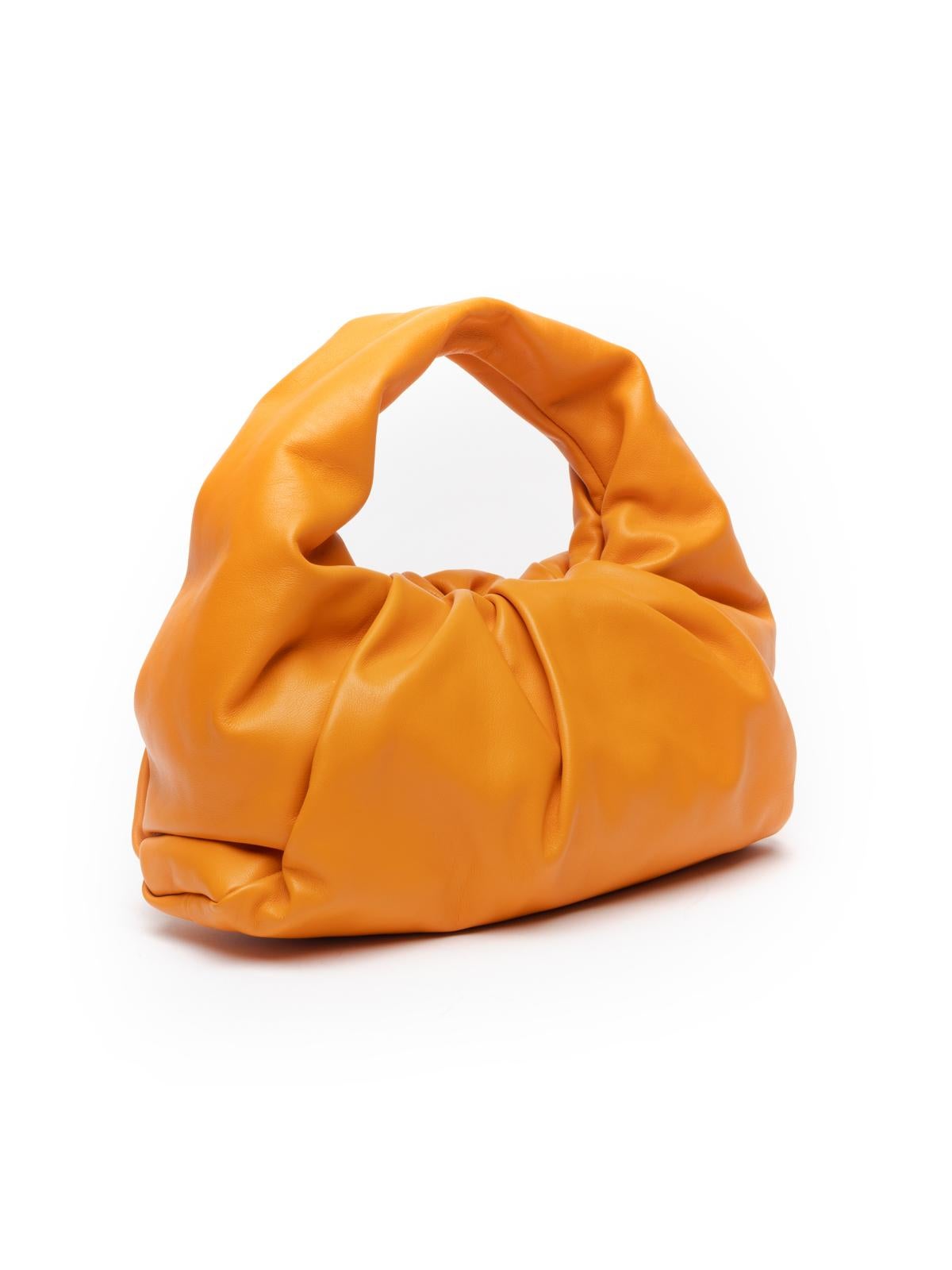 Editor\\\'s Note Throw this luxury consignment Bottega Veneta Shoulder Pouch bag over your shoulder to instantly enhance any designer resale outfit. Boasting exquisite orange lambskin, it is the perfect choice from our range of high end consignment