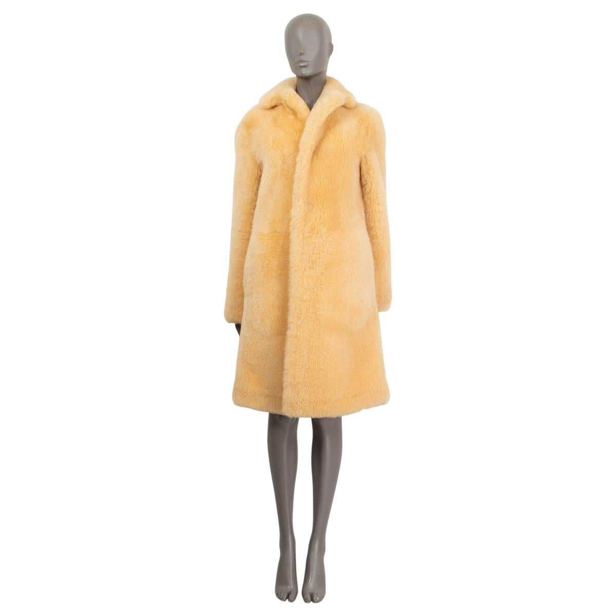 100% authentic Bottega Veneta long coat in light yellow lamb shearling (100%). Features a notch collar and two slit pockets on the front. Opens with three push buttons on the front. Unlined. Has been worn once and is in virtually new condition.