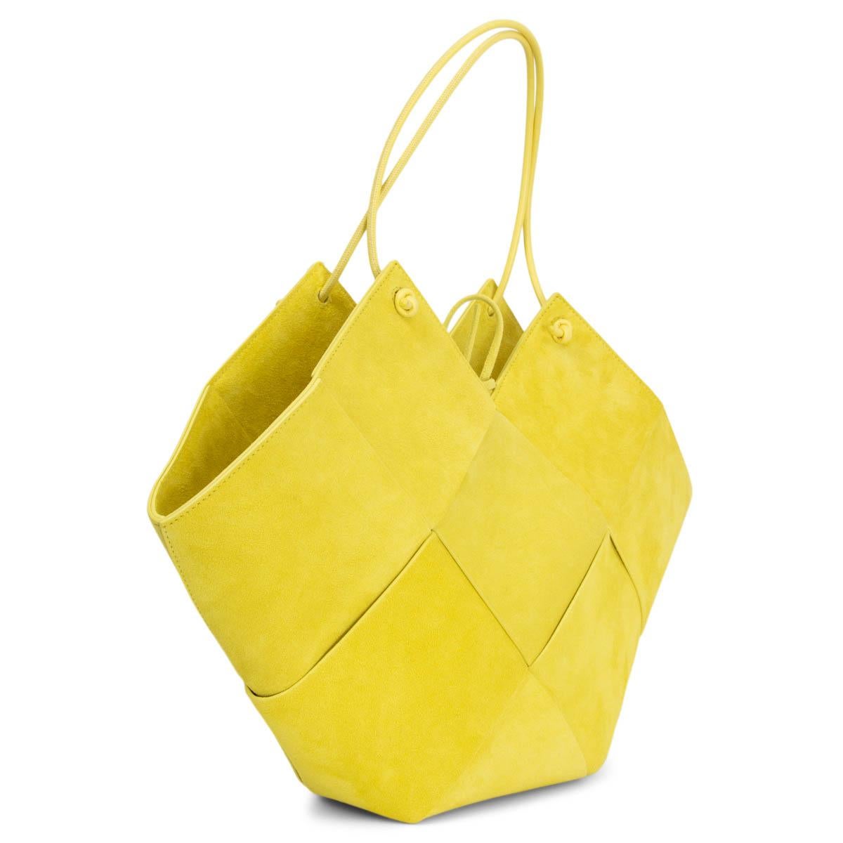 100% authentic Bottega Veneta Flower Basket Small tote bag in Sherbet-Silver (neon yellow) intrecciato suede. It has slender leather top handles that can also be slung over the shoulder. Unlined. The internal zipped pouch is ideal for storing your