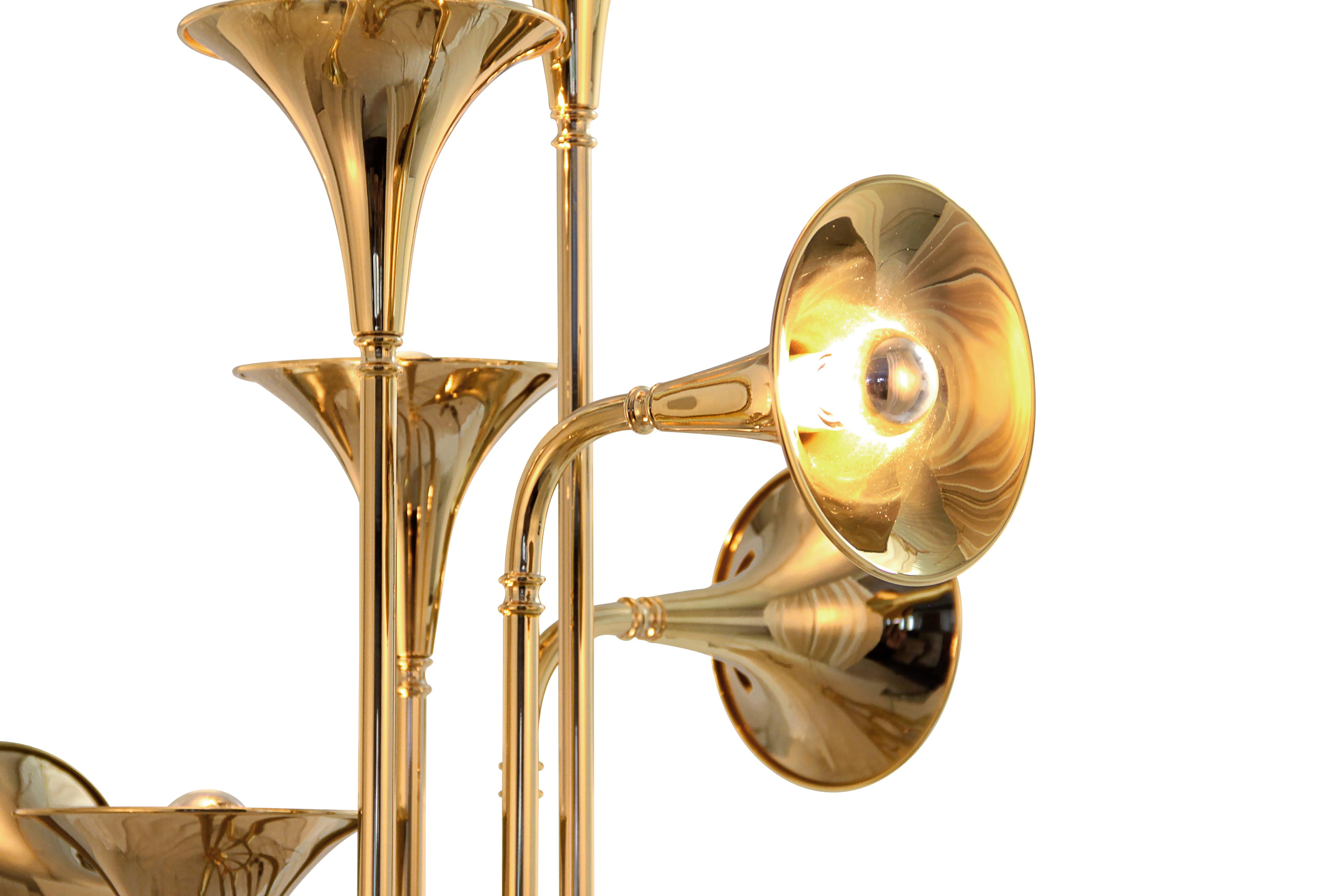 Botti floor lamp was inspired by the jazz musician of Chris Botti. The mid-century floor lamp is handmade in brass with a gold plated finish that reminds of a real trumpet due to its unique shape. With an aluminum base, this modern floor light can