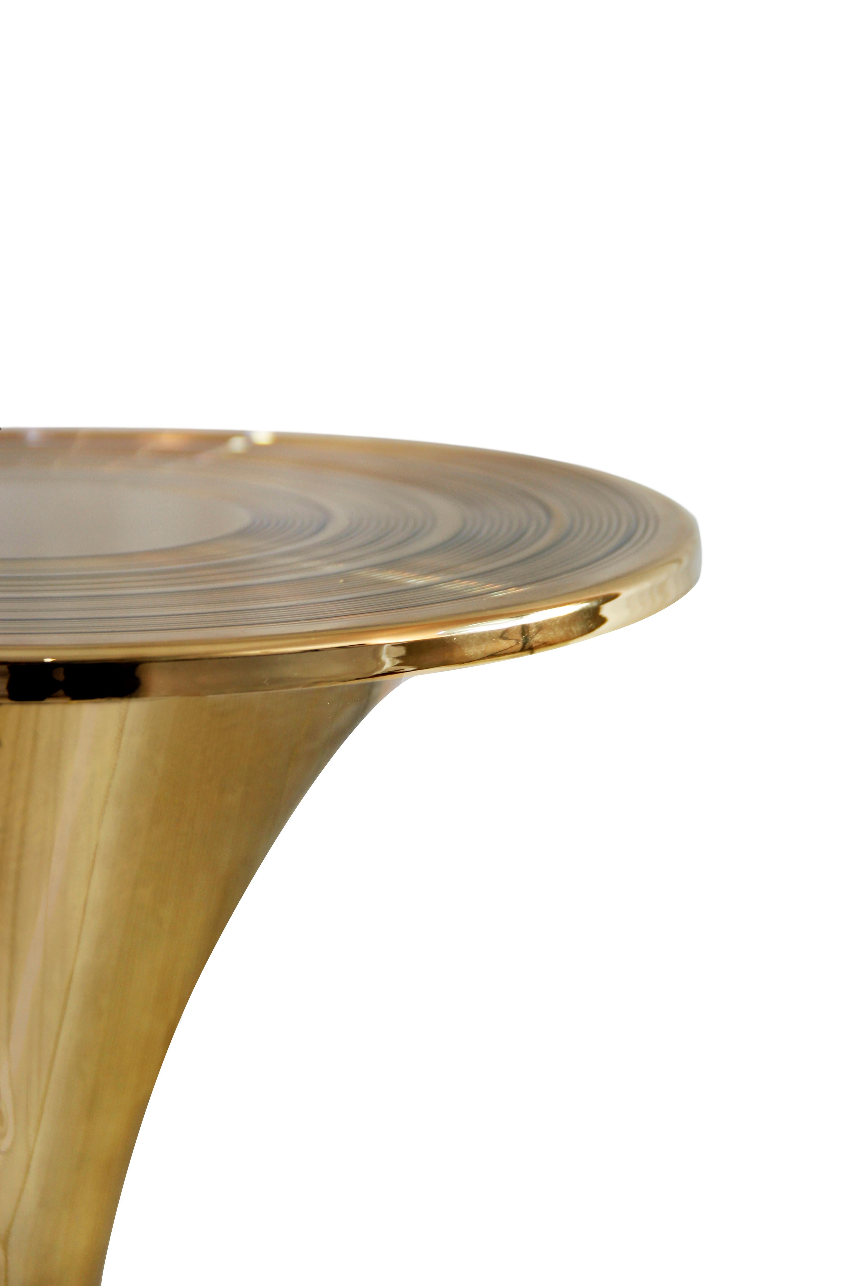 Mid-Century Modern Botti In Gold-Plated Brass Side Table by Essential Home

A Mid-Century Modern Botti in Gold-Plated Brass Side Table by Essential Home, an exquisite round table features a trendy circular pattern that resembles the growth ring of
