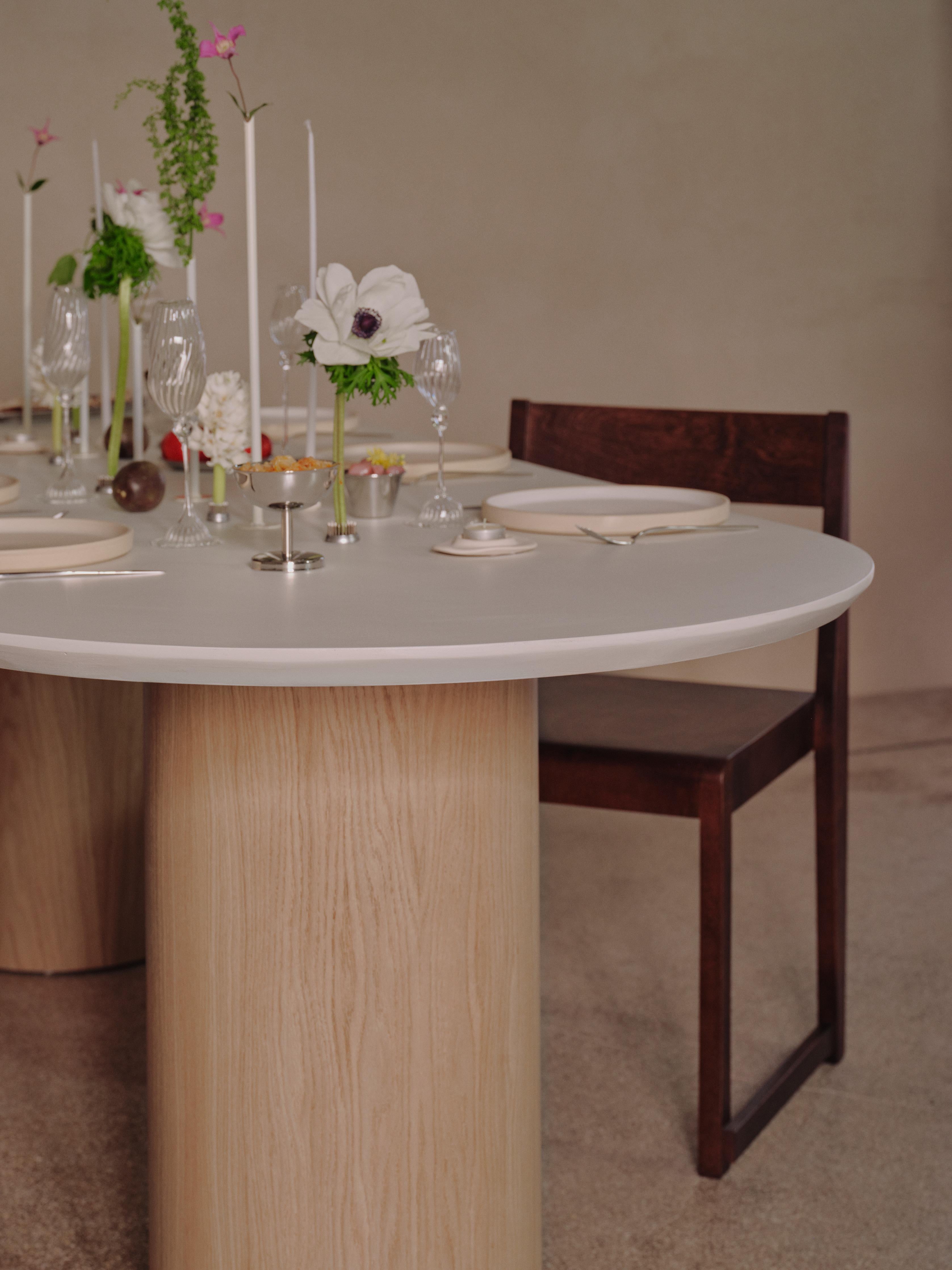 Handcrafted in Spain by expert artisans, this oval-shaped dining table from Marlot Baus combines timeless design with modern craftsmanship. Each piece is carefully made using our signature microcement technique, layered by hand to achieve a smooth,