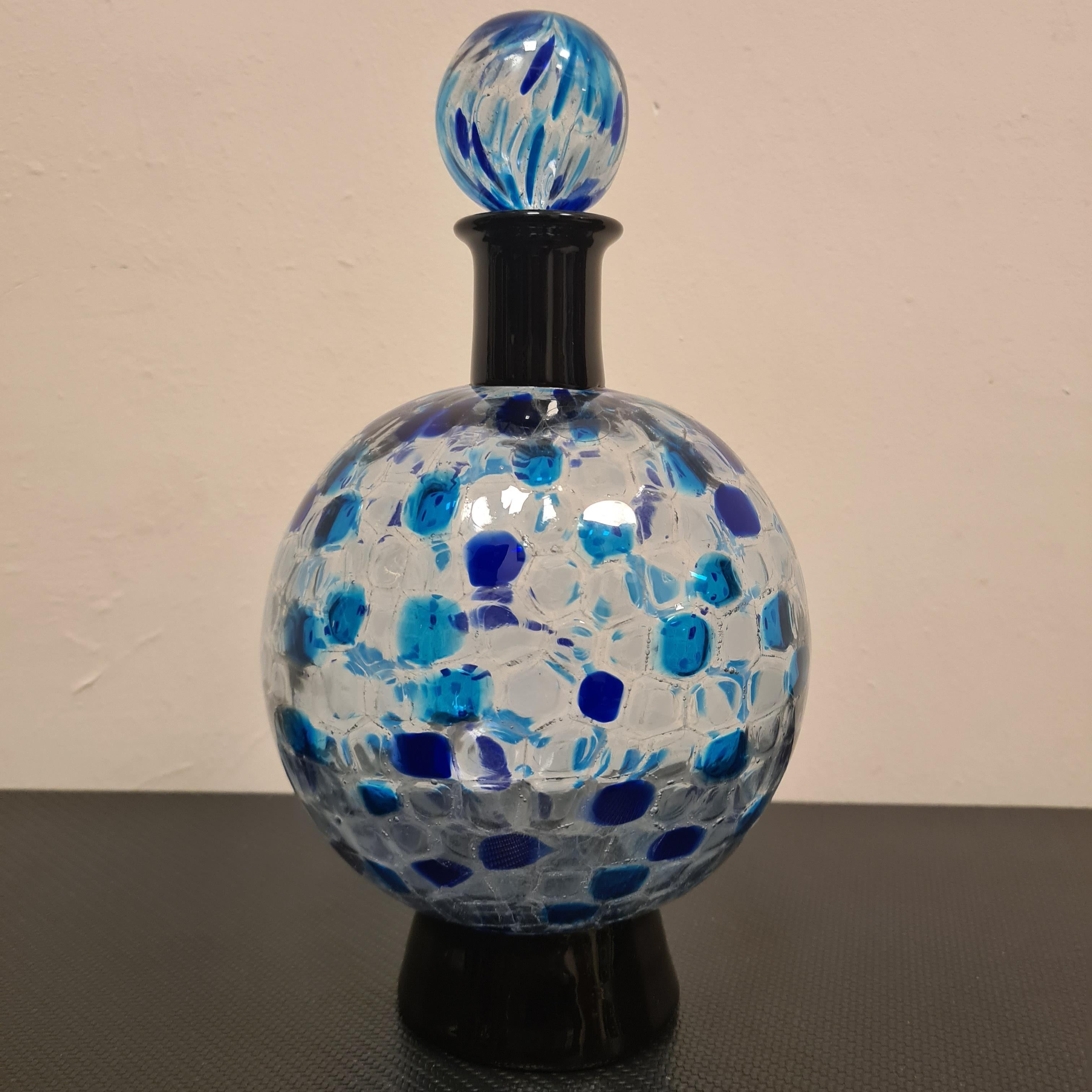 Chambord bottle designed by Alessandro Mendini for Venini.

Rare spherical-shaped blown glass bottle with verdemare murrine and sapphire decoration with black glass neck and truncated base.

Refined and elegant this collectible bottle is a unique