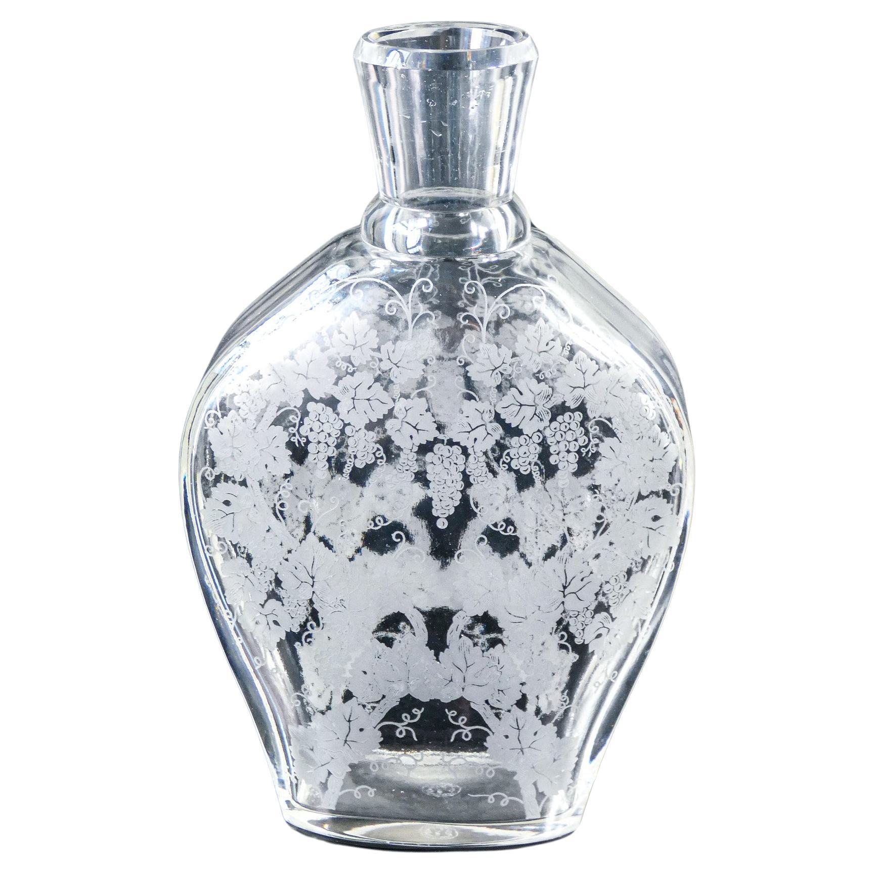 BACCARAT crystal bottle, motif depicting a vine and bunches of grapes
