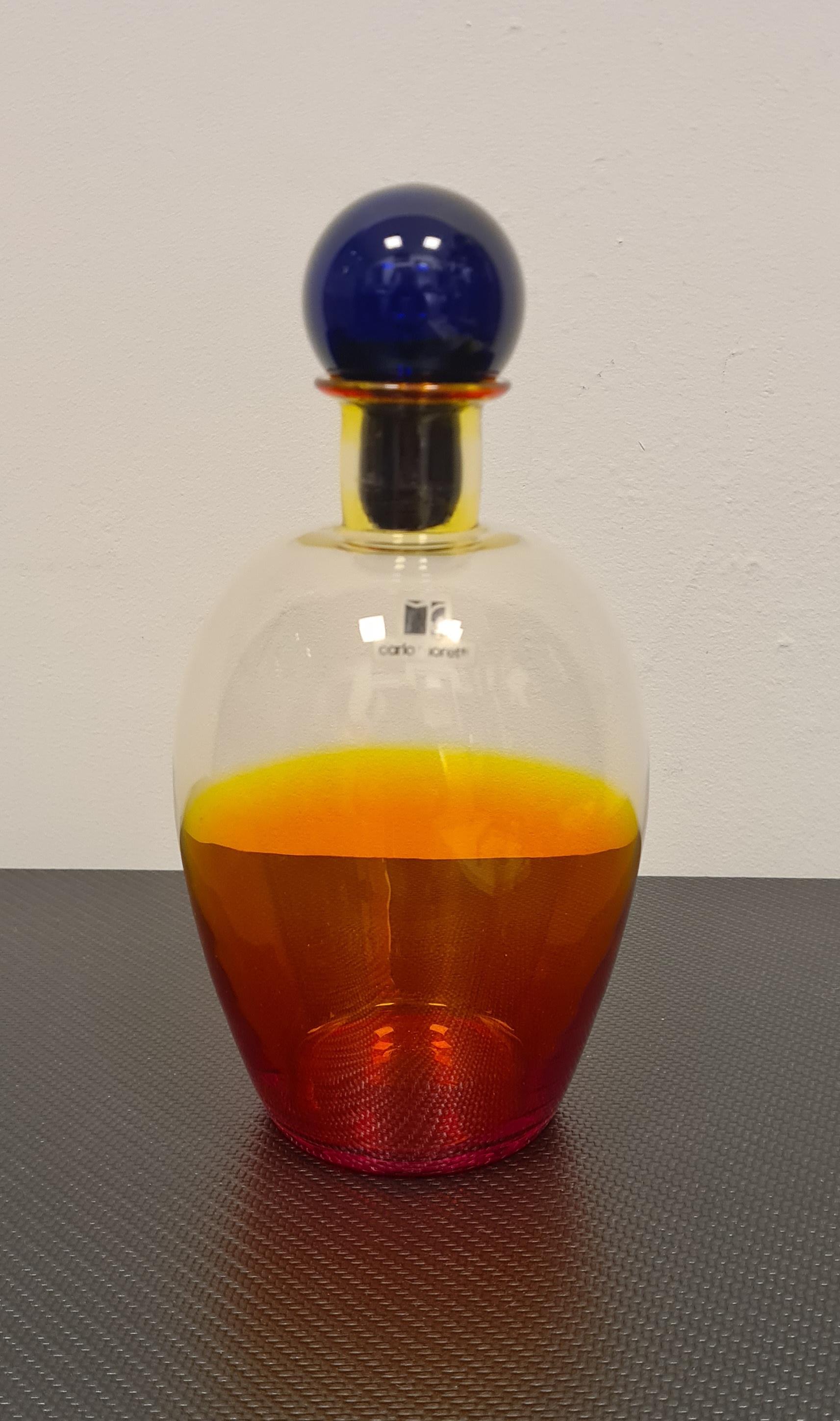 Murano glass bottle by master Carlo Moretti.

Carlo Moretti founded his eponymous glassworks in 1958 in Murano with his brother Giovanni.

Throughout its history Moretti Glassworks has had numerous collaborations including one with a very young