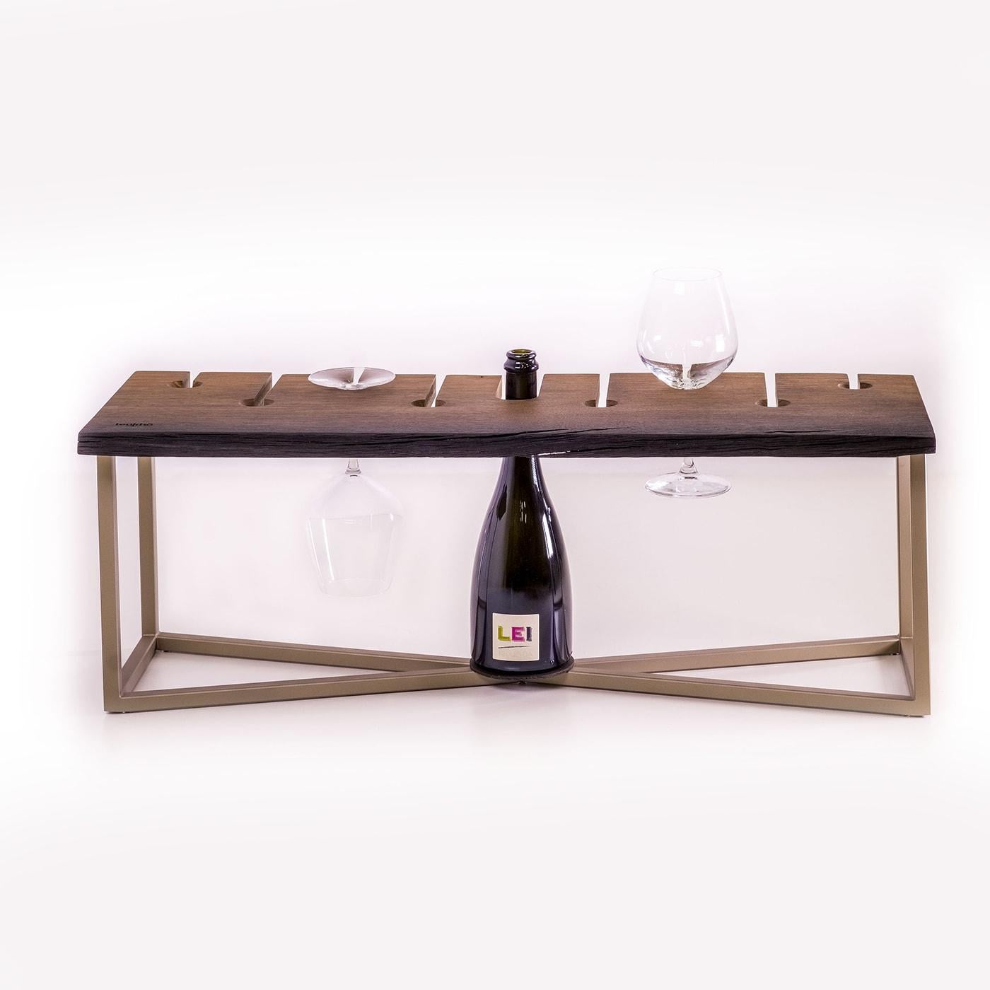 An elegant tray with inserts for 1 bottle and 8 glasses. On the front side, a space for placing small tapas. The frame is in Champagne painted metal. Finished with transparent oil suitable for contact with food. Design: Luca Degano.