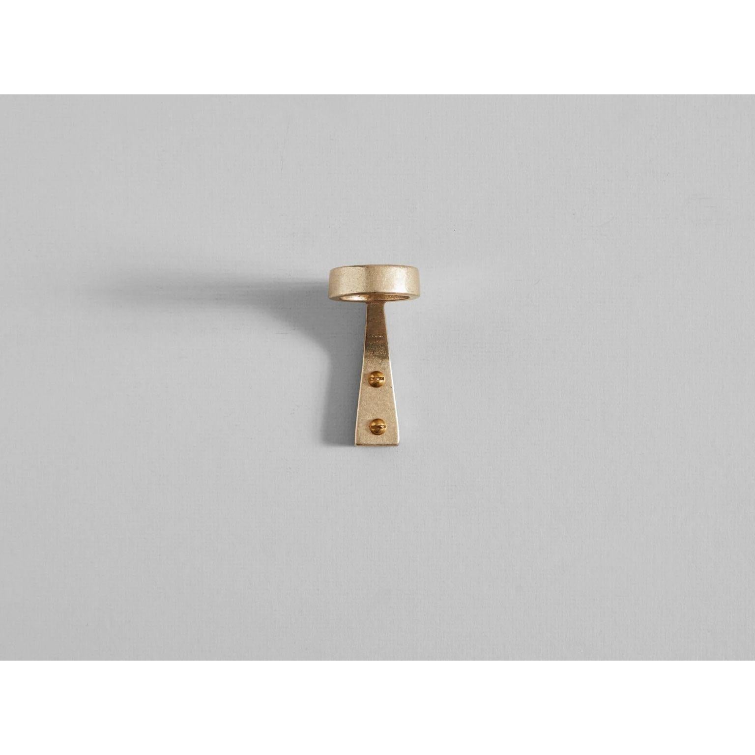 Brass Bottle Bracket by Henry Wilson
Dimensions: W 4 x D 7 x H 8 cm
Materials: Aluminium, Brass, Black Bronze

Bottle Bracket is a solid, hand poured brass form available in dual or single bottle configuration.
The Bottle Bracket is manufactured in