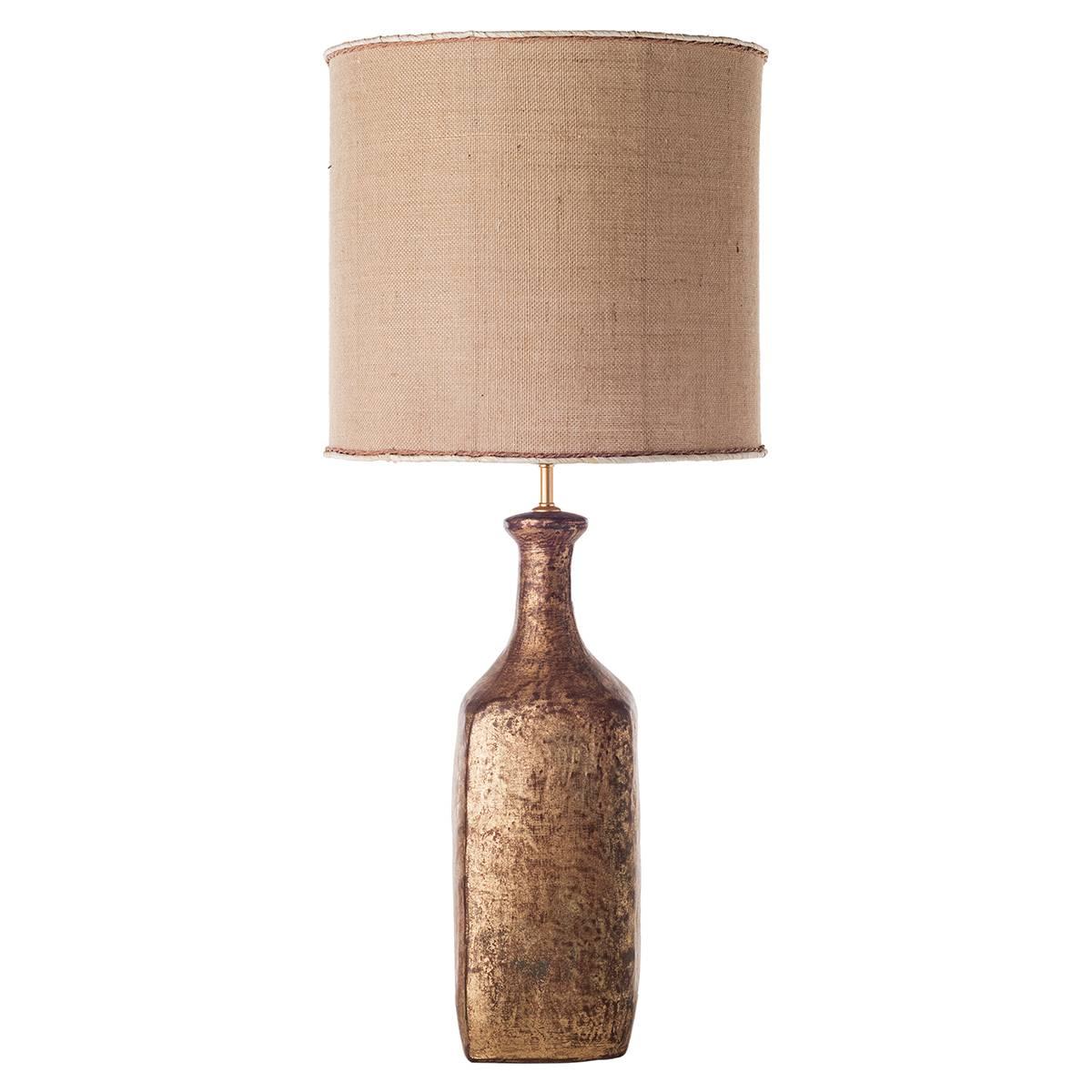 Bottle ceramic table lamps with shades.
The body of the lamps is characterized by a bottle shape and is decorated with a refined rusty-brown finish. The table lamps are completed by a cylindrical shade in sand color. Warm and rustic colors make them
