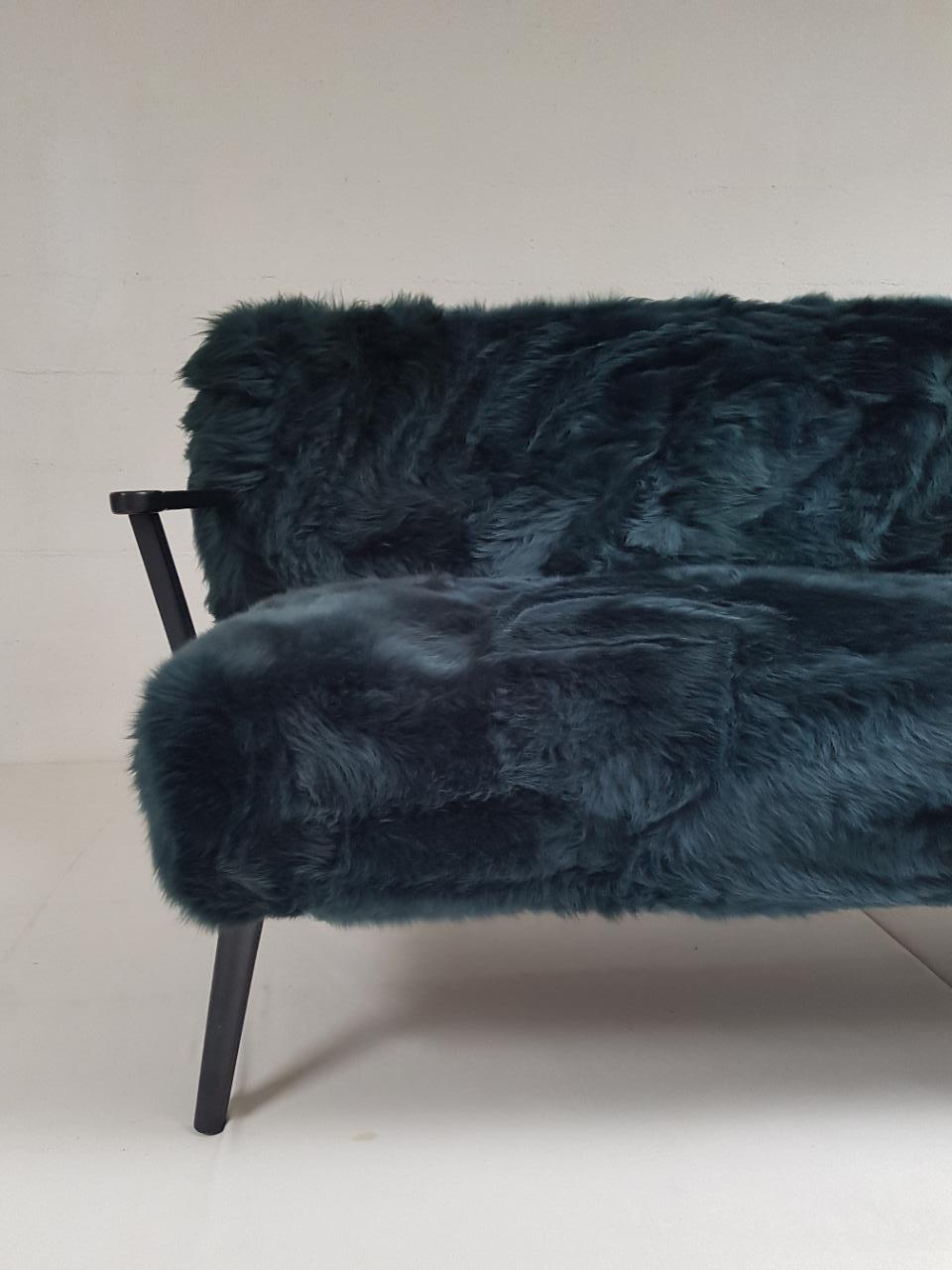 Very comfortable sofa with dyed dark green sheepskin upholstery.
Solid oak legs and arms.