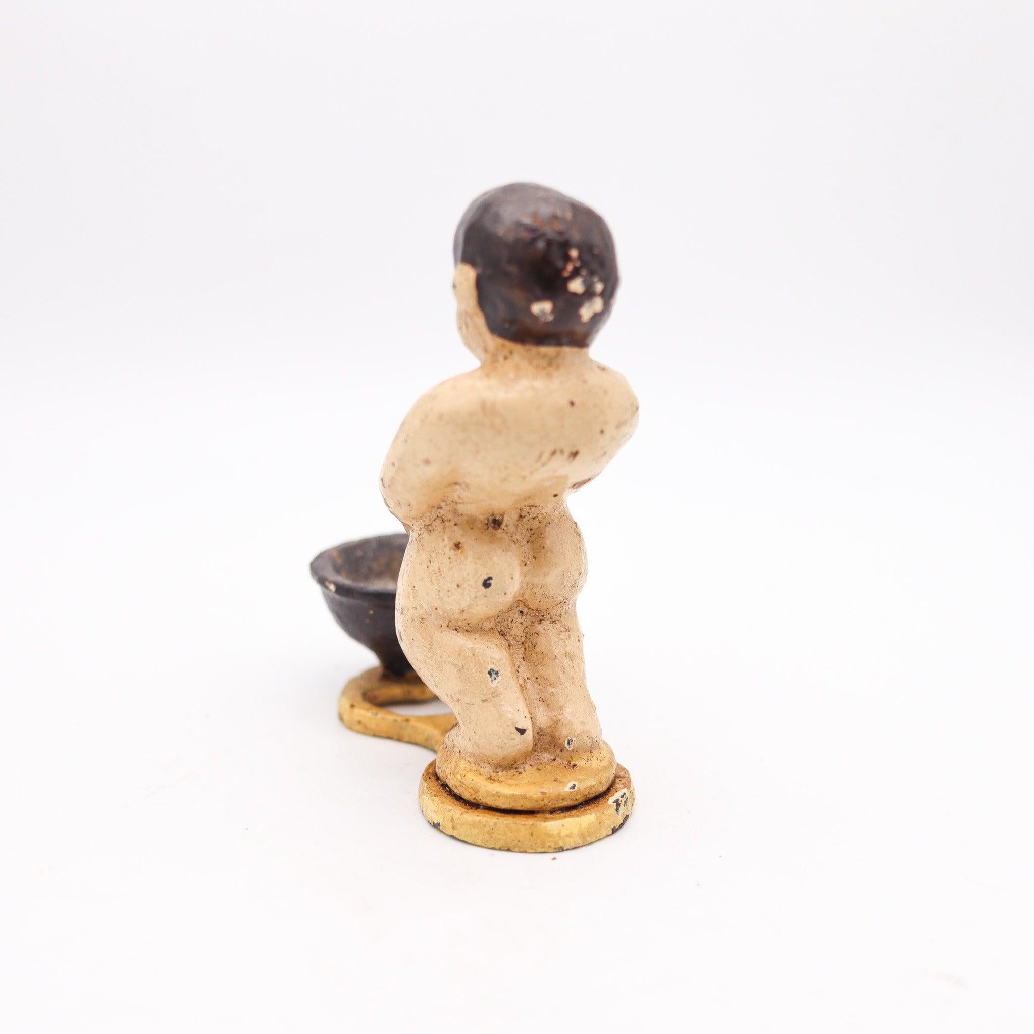 Antique bar figurative cast iron bottle opener.

This is an elusive antique bar bottle opener created in America during the turn of the 19th century, back in 1900 and 1910. Crafted in the shape of the iconic mannequin piss in Brussels in solid cast