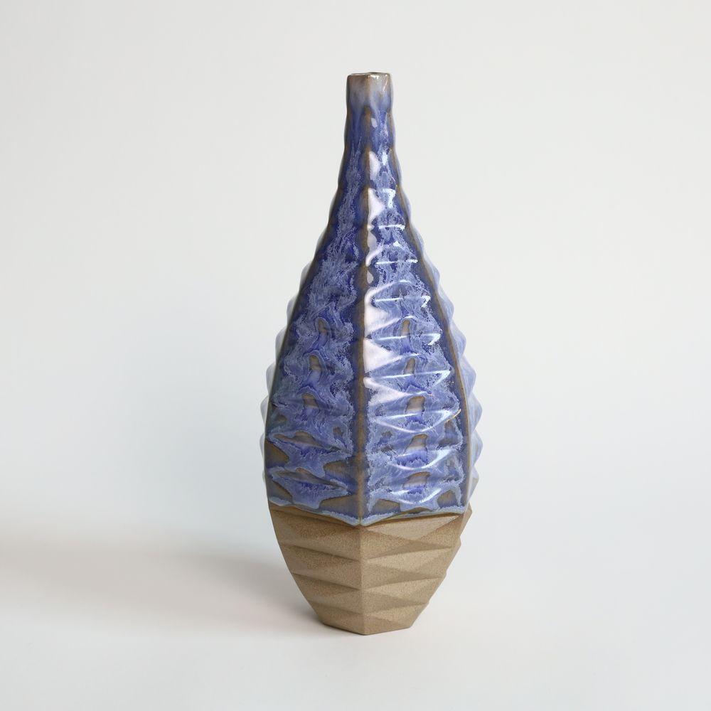 Bottle Patterned Vessel in Coral Blue
Introducing the Bottle Patterned Vessel, a beautiful and contemporary piece of art that seamlessly blends traditional craftsmanship with modern design. This stunning vase features an intricate pattern that