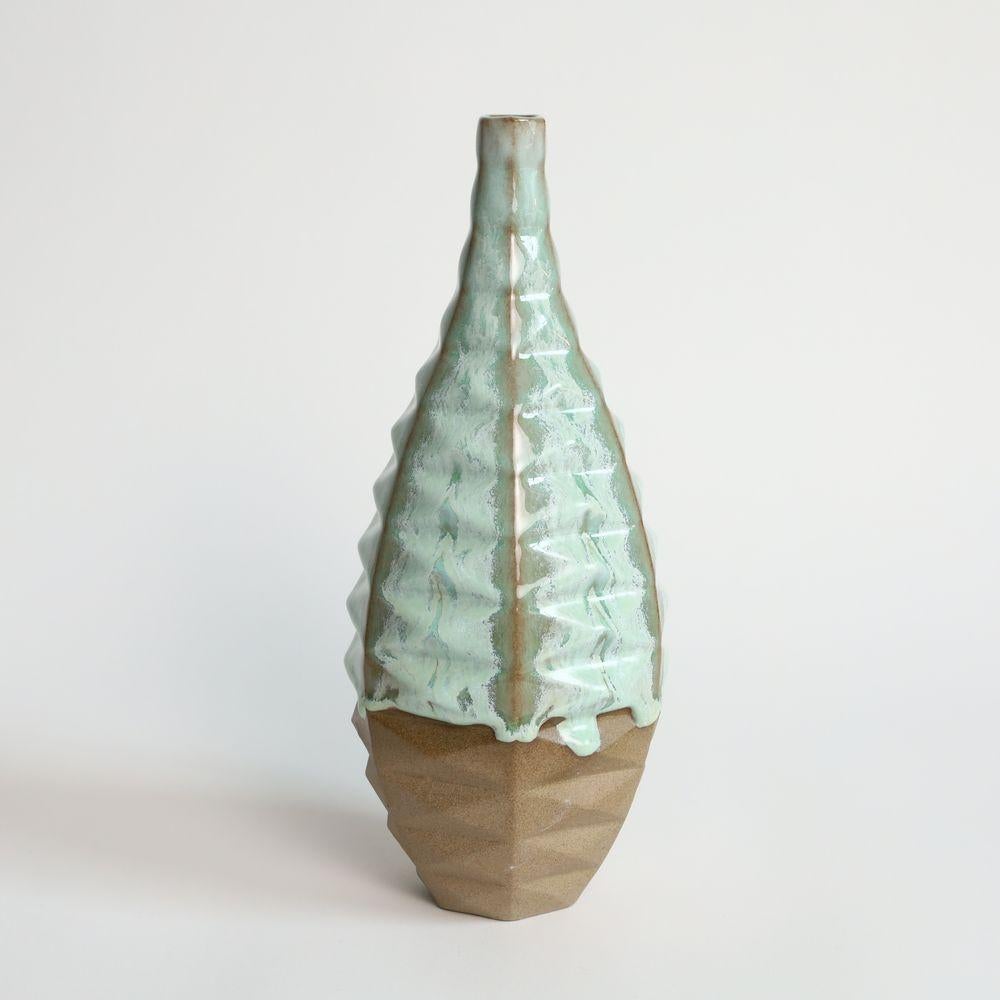 Bottle Patterned Vessel in Coral Green
Introducing the Bottle Patterned Vessel, a beautiful and contemporary piece of art that seamlessly blends traditional craftsmanship with modern design. This stunning vase features an intricate pattern that