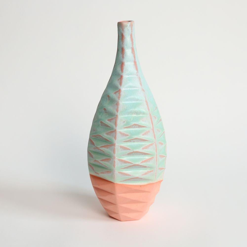 Bottle Patterned Vessel in Strawberry Pistachio
Introducing the Bottle Patterned Vessel, a beautiful and contemporary piece of art that seamlessly blends traditional craftsmanship with modern design. This stunning vase features an intricate pattern