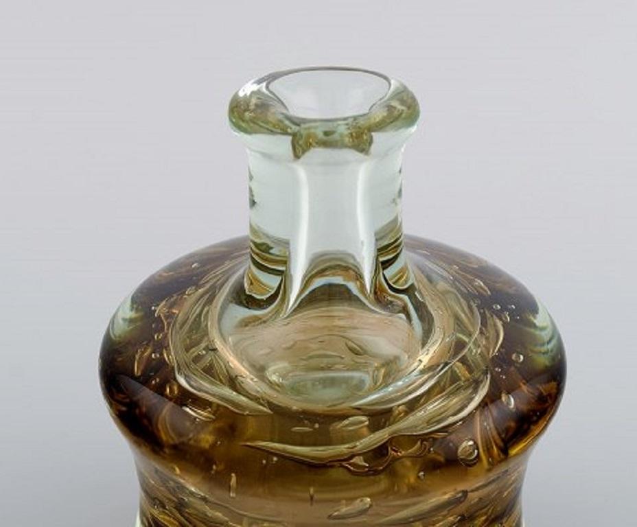 Bottle shaped Murano vase in clear and smoky mouth-blown art glass. Italian design, 1960s-1970s.
Measures: 14.5 x 13 cm.
In excellent condition.