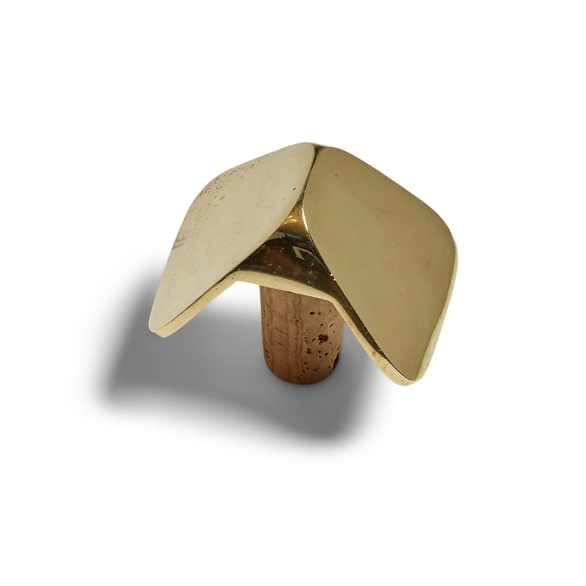 A solid bronze bottle stopper in the form of a bow tie. Marked 